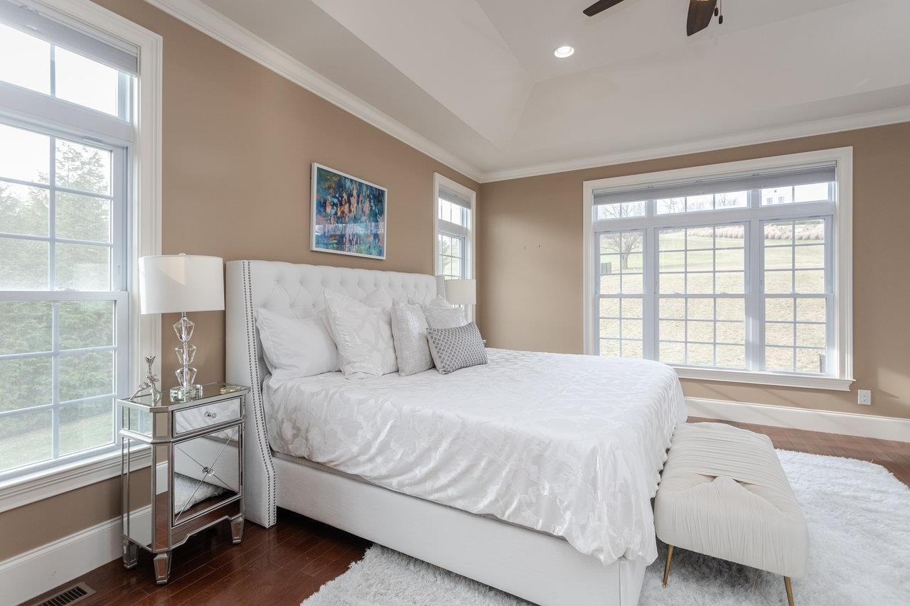 Tranquility to start and end your day in this beautifully painted primary bedroom with large windows and boxed ceiling.