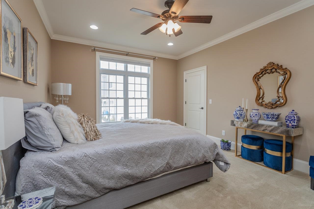 Bright and spacious second bedroom with crown moulding, recessed lighting and ceiling fan.