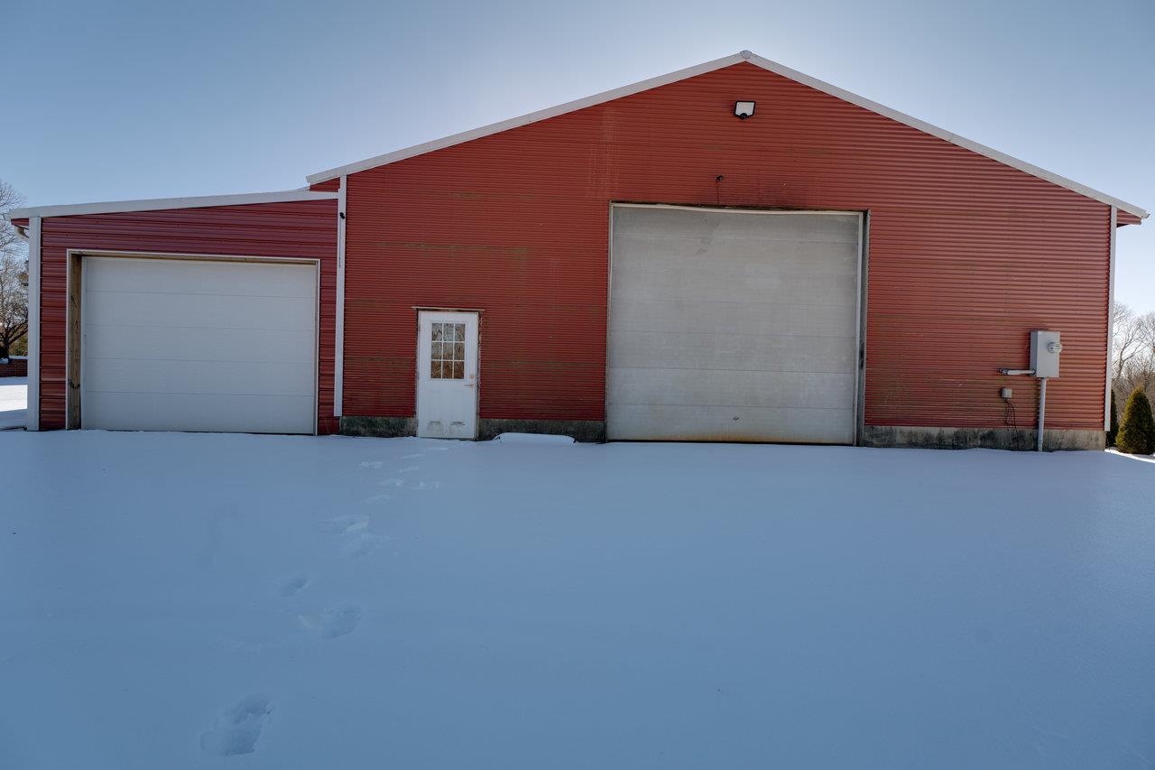 Auto body shop has an extra car garage plus the shop