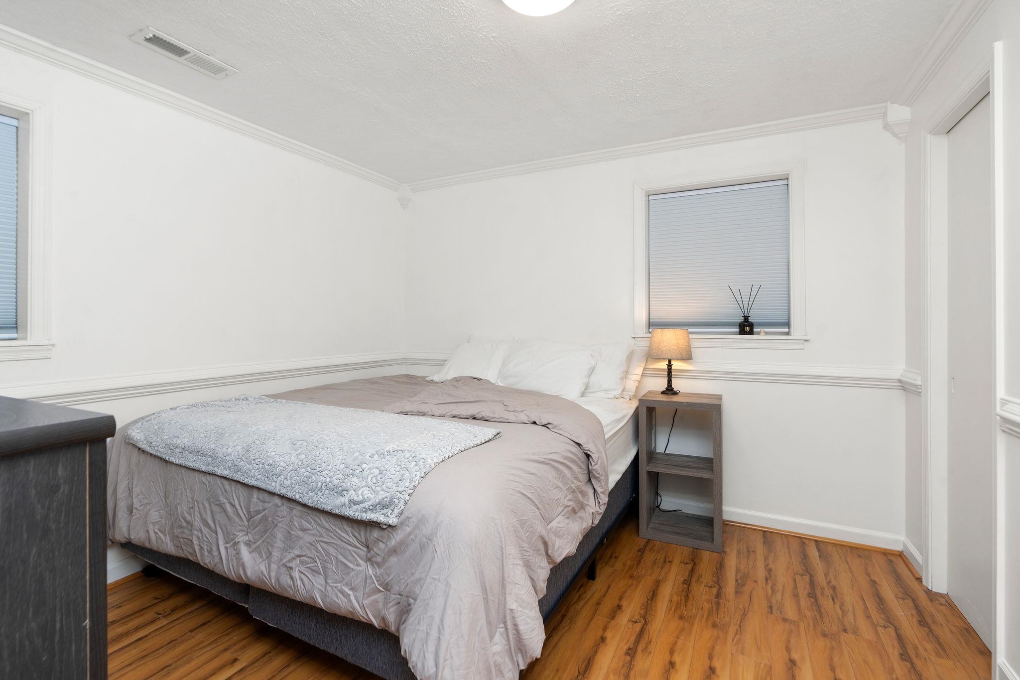 bedroom with 2 windows and 2 closets.