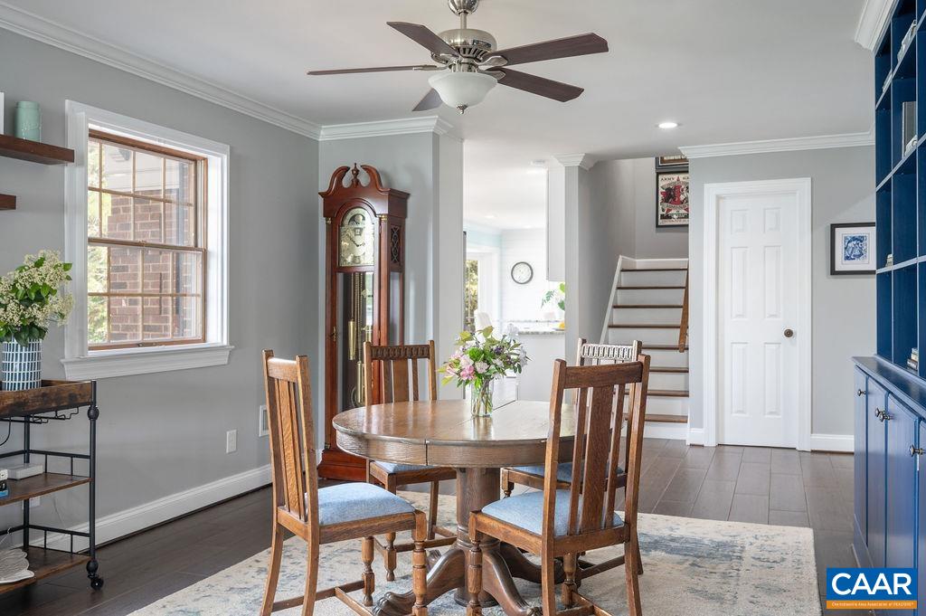 Breakfast room with built-in cabinetry opens out onto expansive rear patio