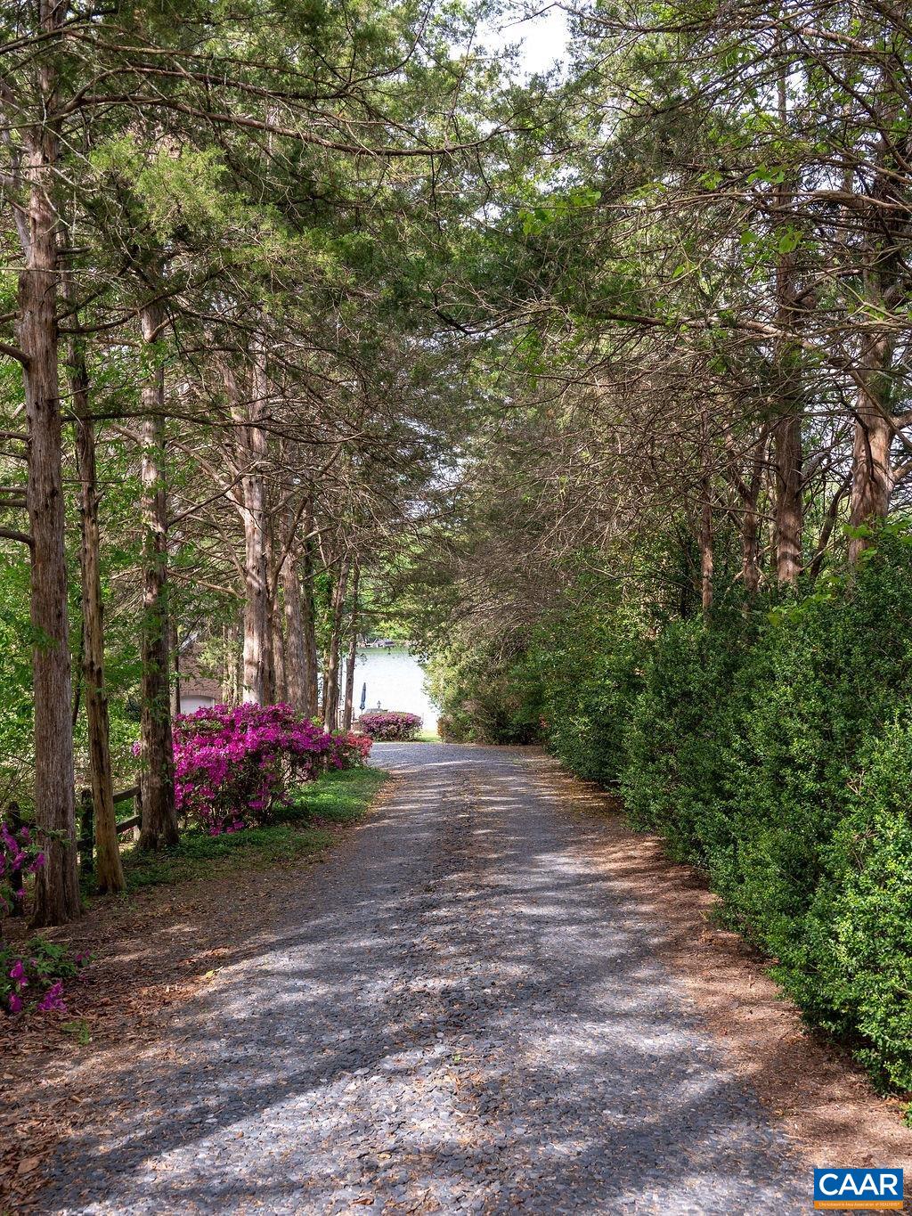 Home is set back privately from street through tree lined drive