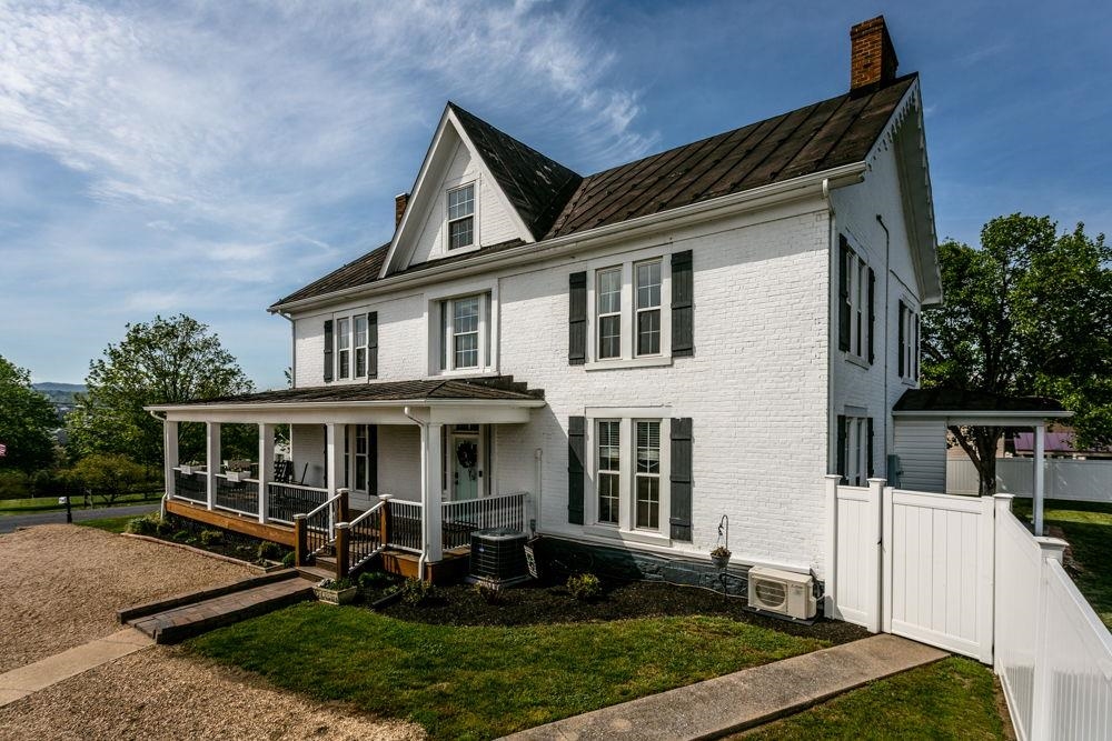 Entrance side of house with parking and room to grow and add a garage!