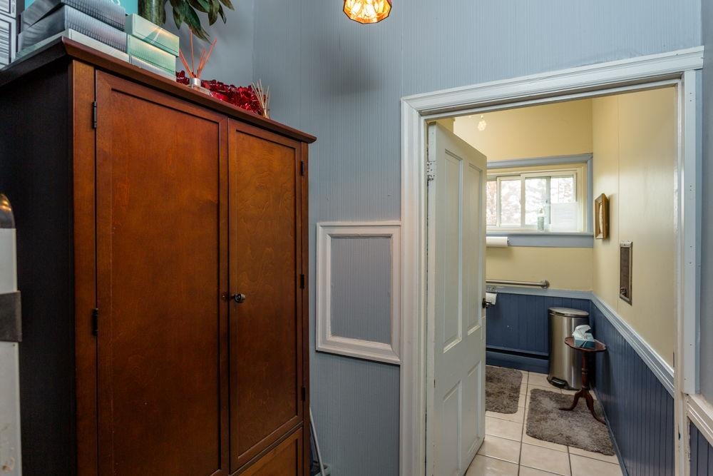 before restroom allows for tall cabinets or make larger restroom.