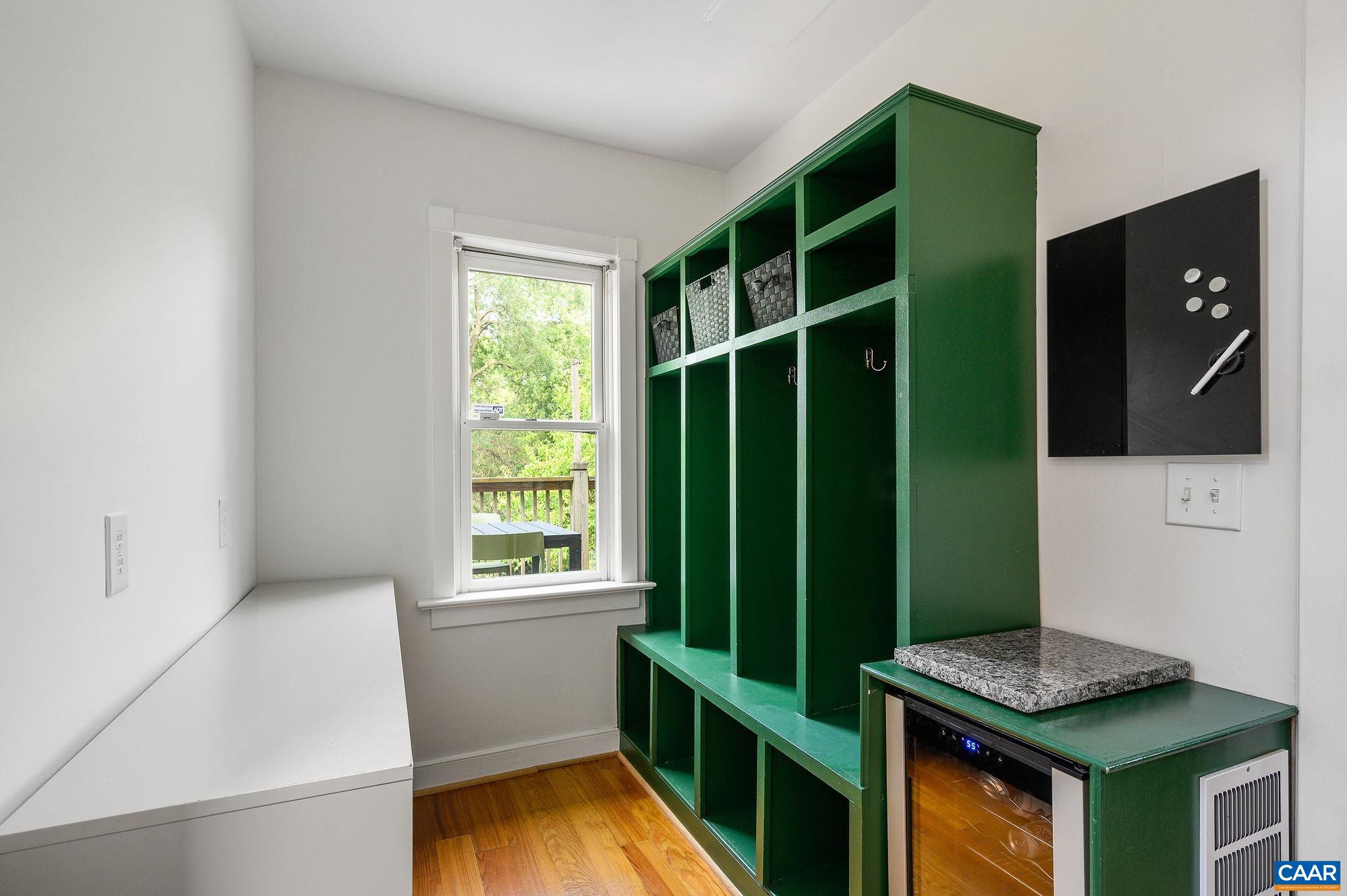 Mudroom has built-in cubbies for shoes, coats, school backpacks,...
