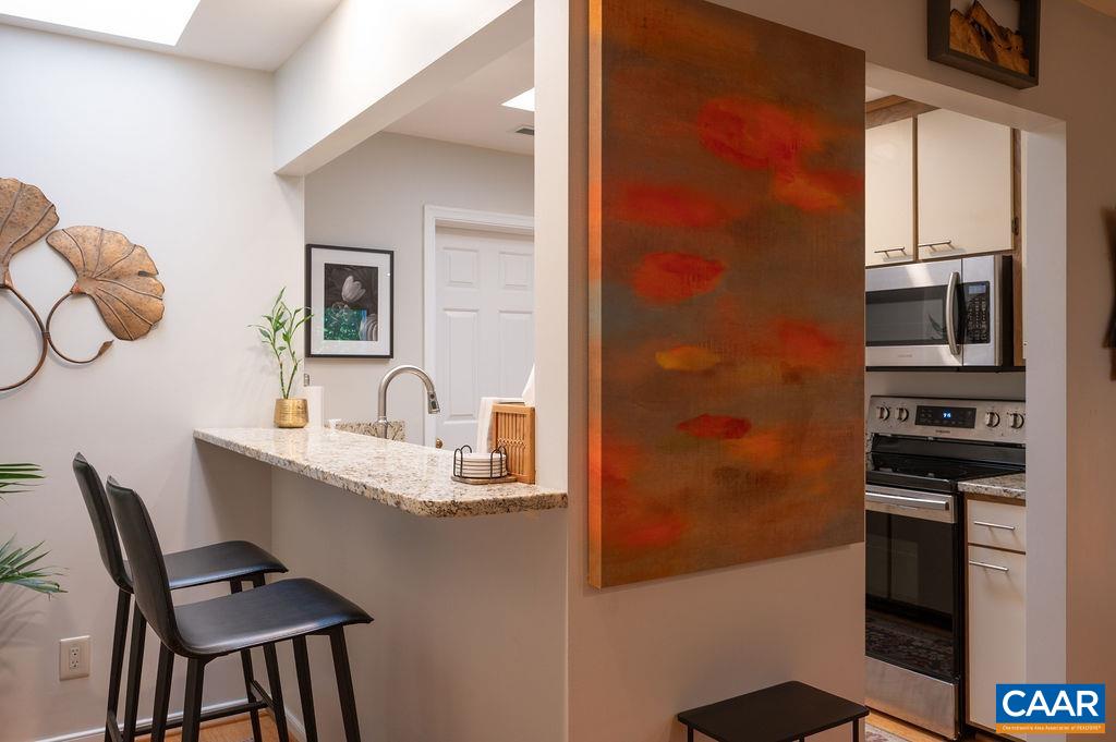 This breakfast bar off the kitchen has a skylight that provides natural light into this area