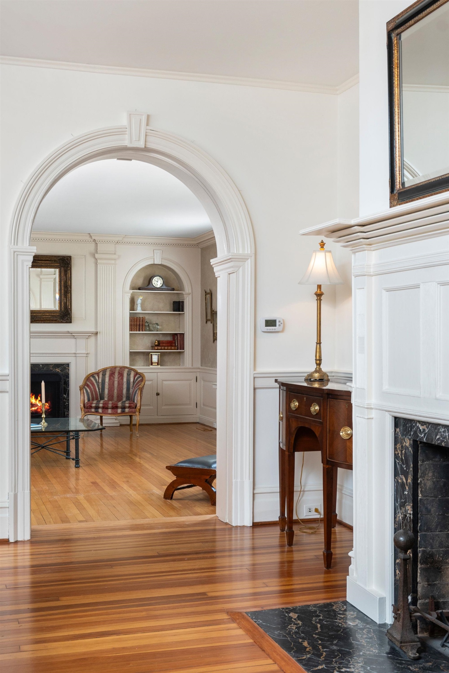 The living room and primary bedroom addition was completed in 1926 with very extensive detail in all the wood work and keystone archway.