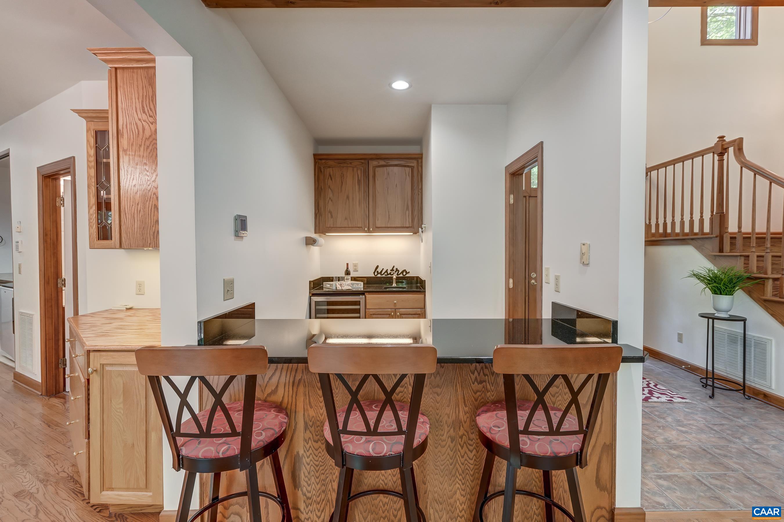 Wet bar with granite counters and wine cooler is great for entertainers.