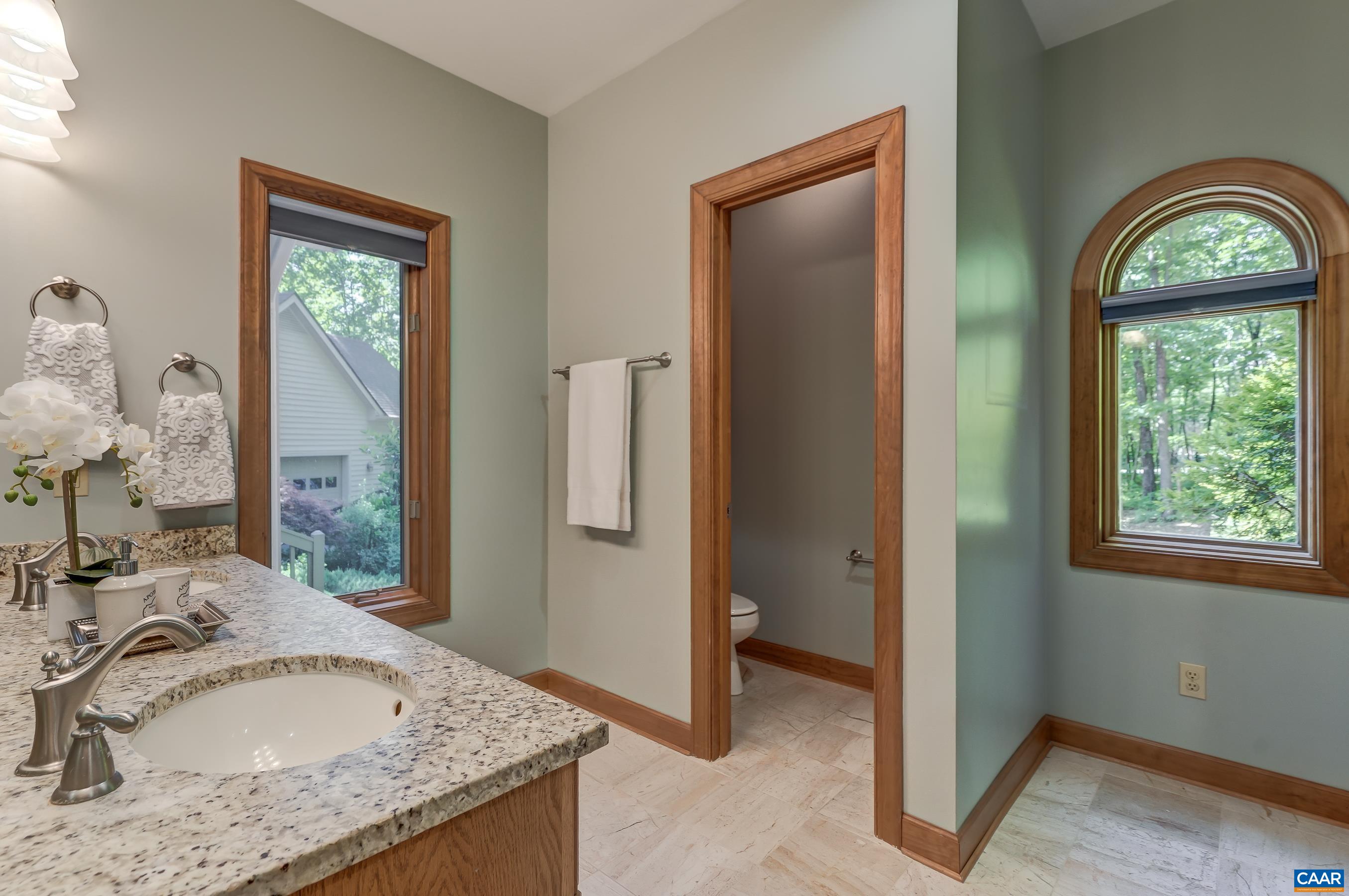 Ensuite bathroom with heated marble floors, shower, and soaking tub.