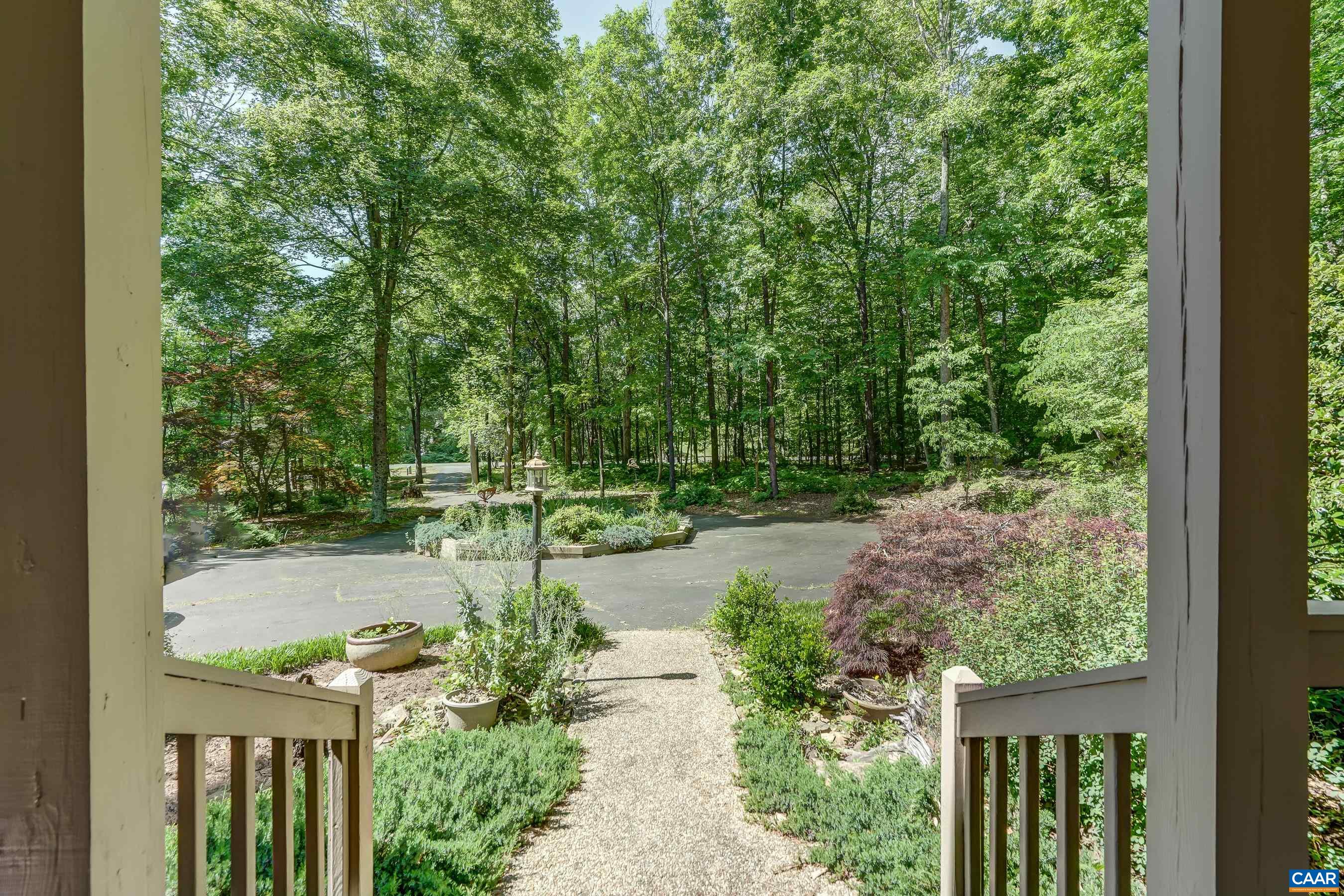 Beautiful landscaping with no grass to mow, and privacy on all sides!