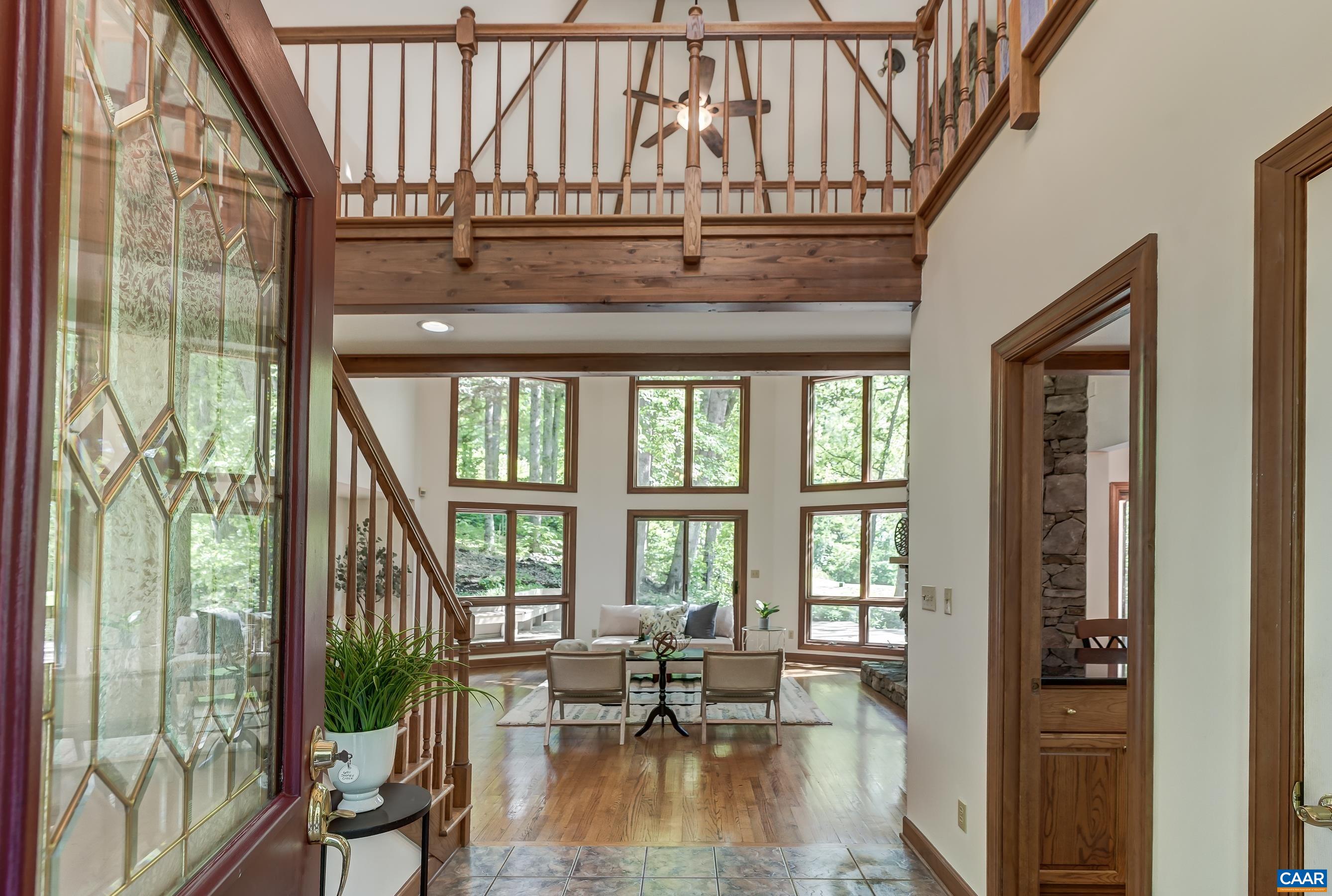 Grand foyer with views out the back through the vaulted great room.