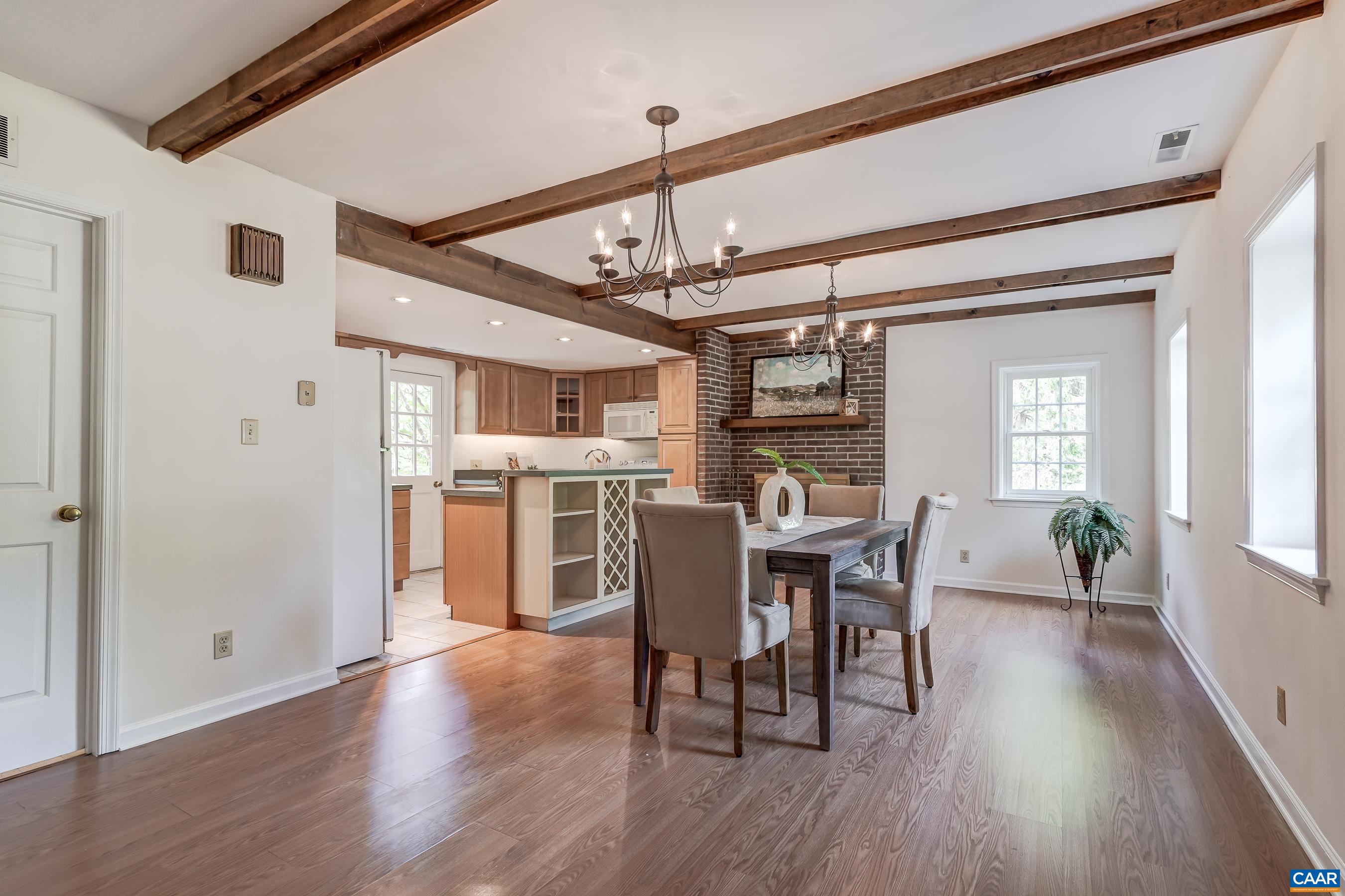 Dining room with brick wood-burning fireplace.