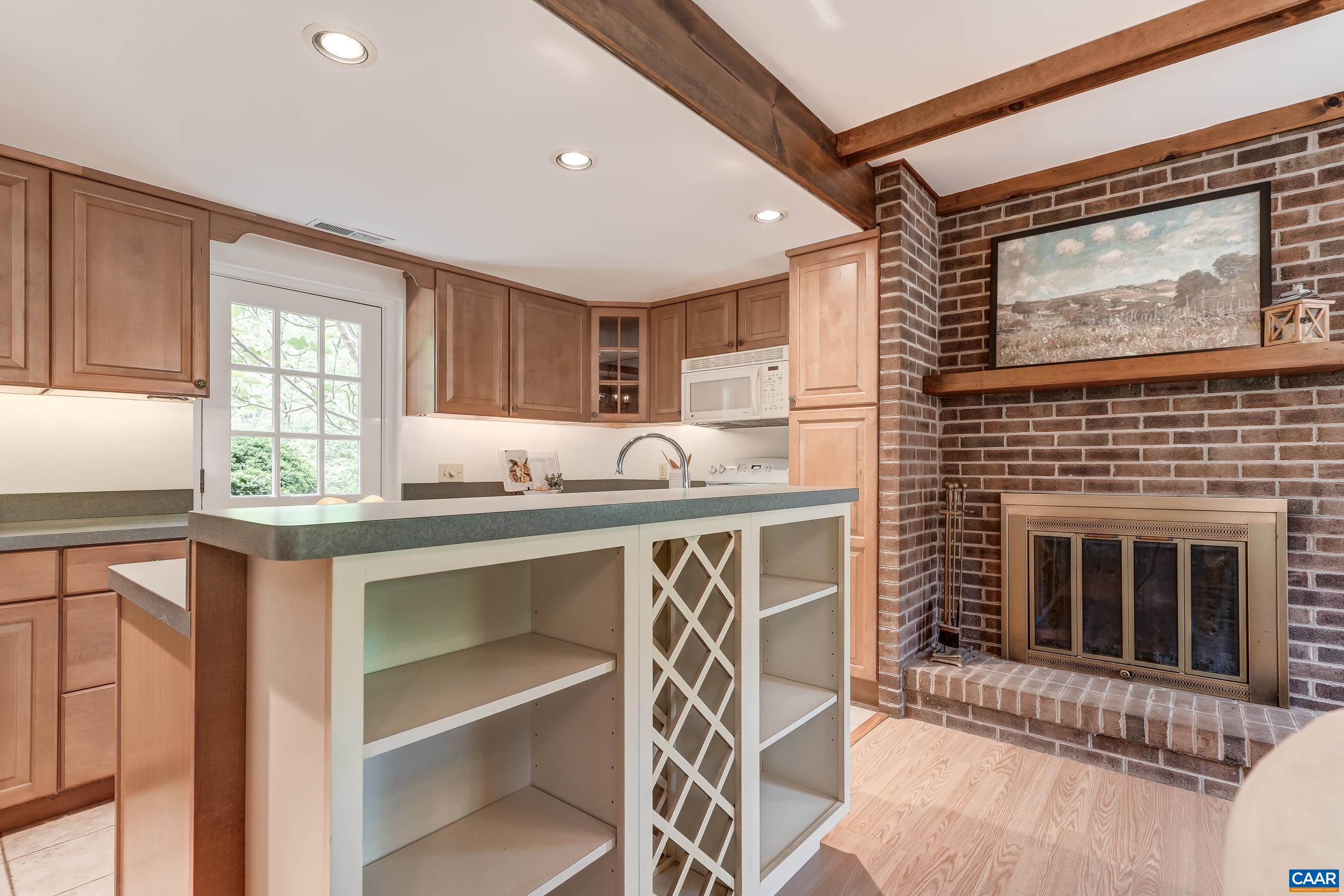 Gourmet kitchen features large island with wine storage .