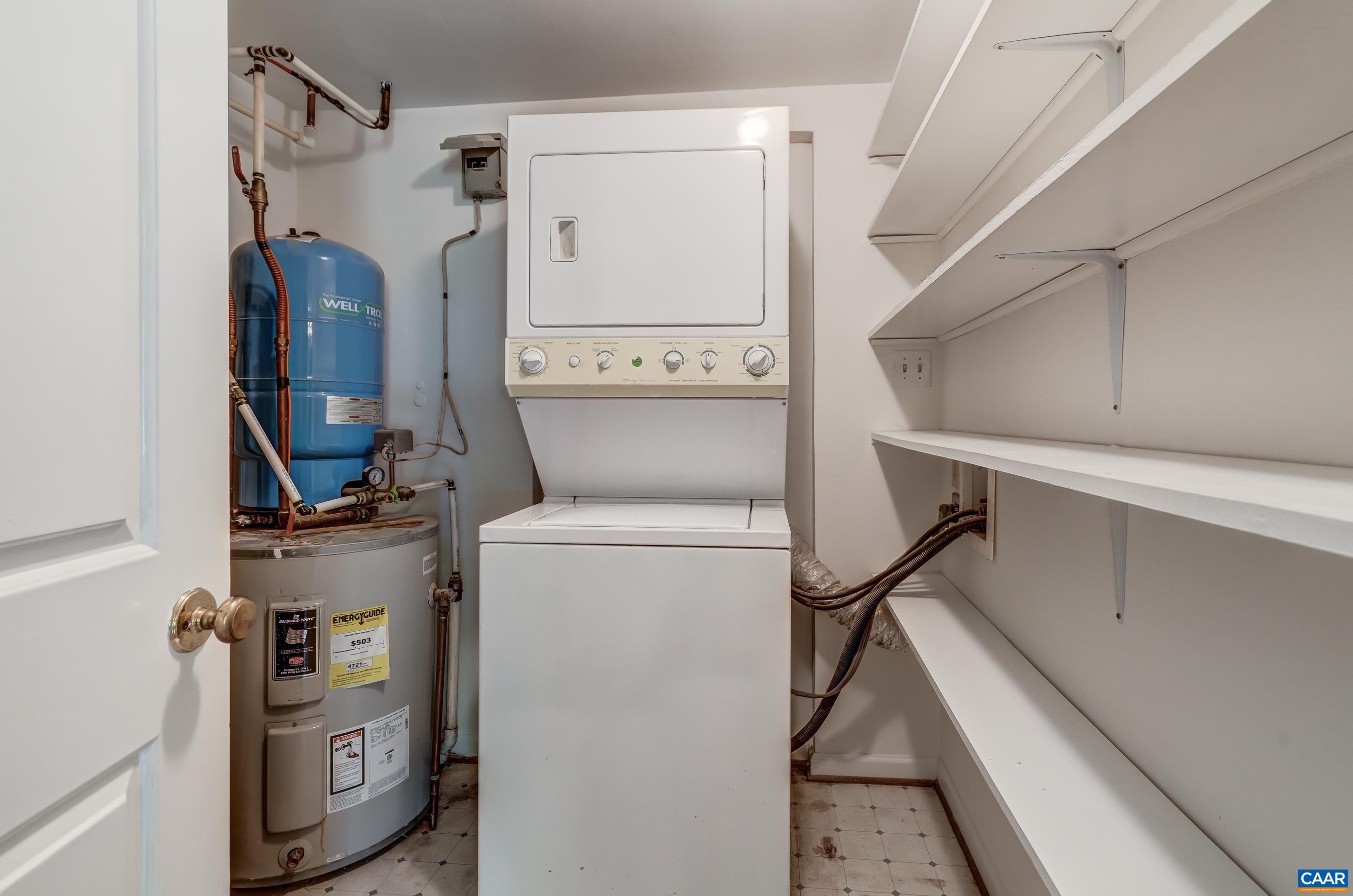 Laundry room with stacked washer and dryer.