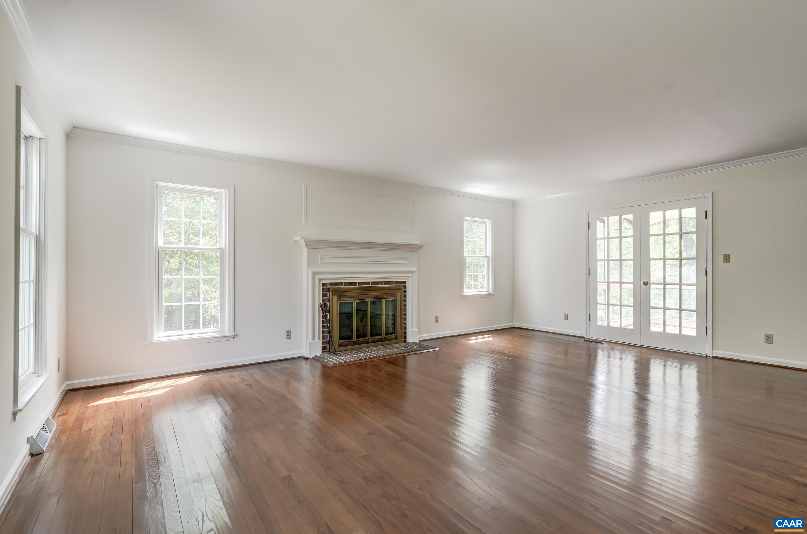 Second floor features a large living room with hardwood flooring and fireplace.