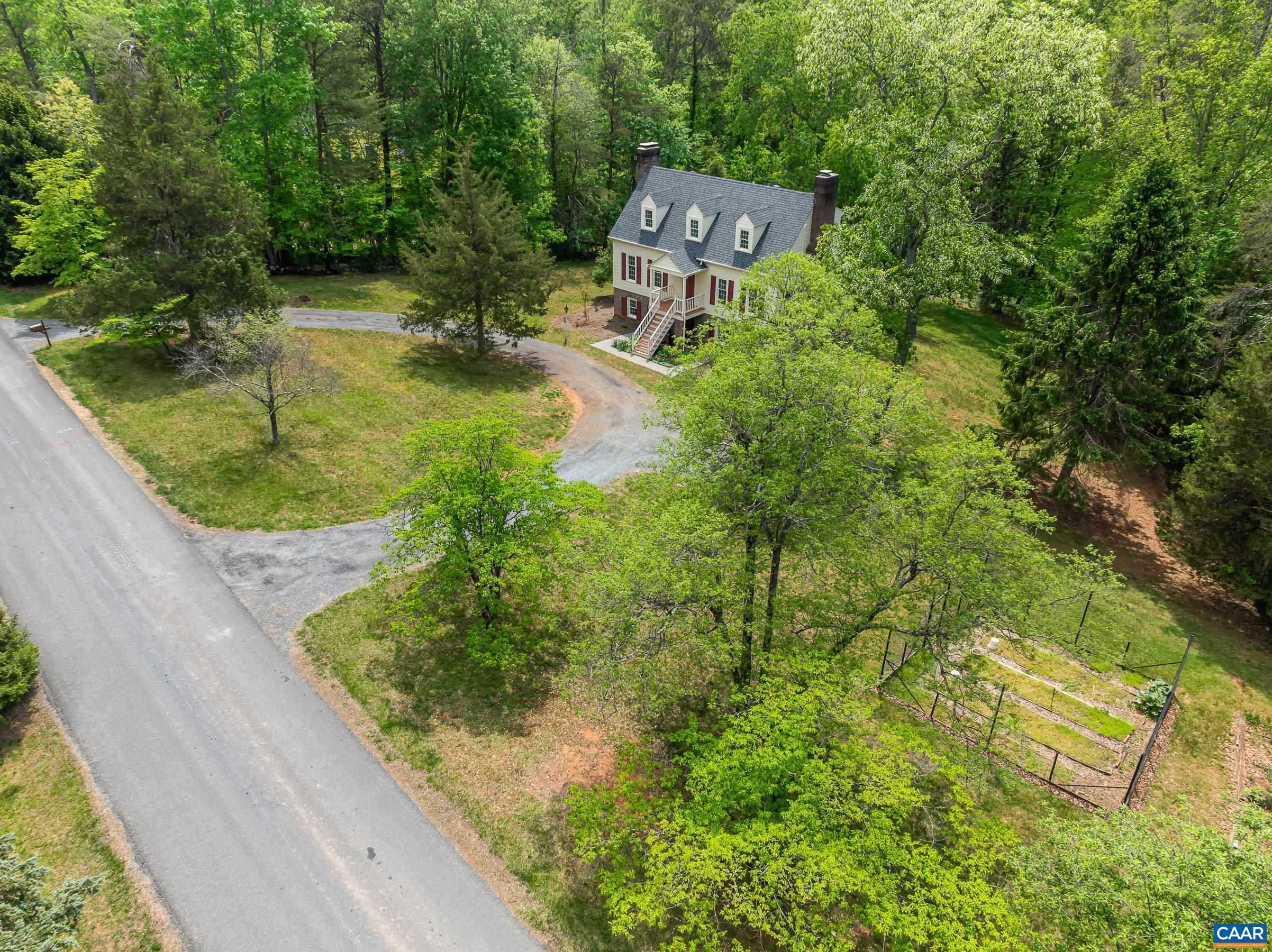 Garden space, storage shed and large driveway.
