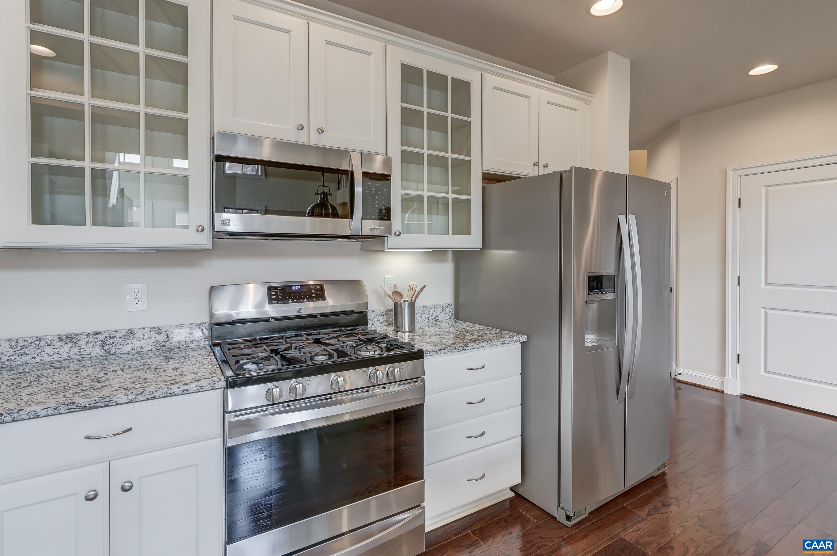 Gas range and glass cabinets.