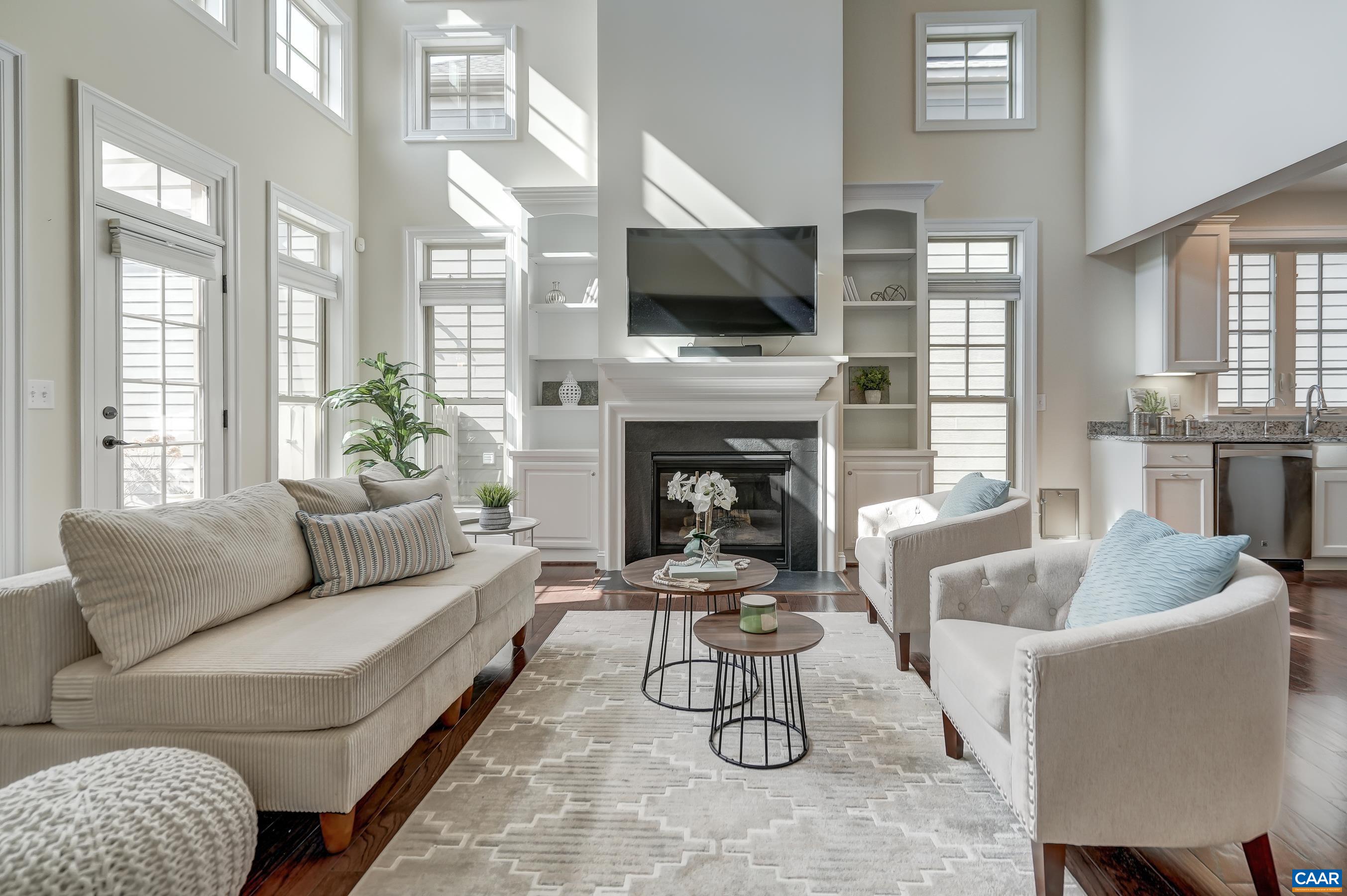 Soaring great room with gas fireplace and built-ins.