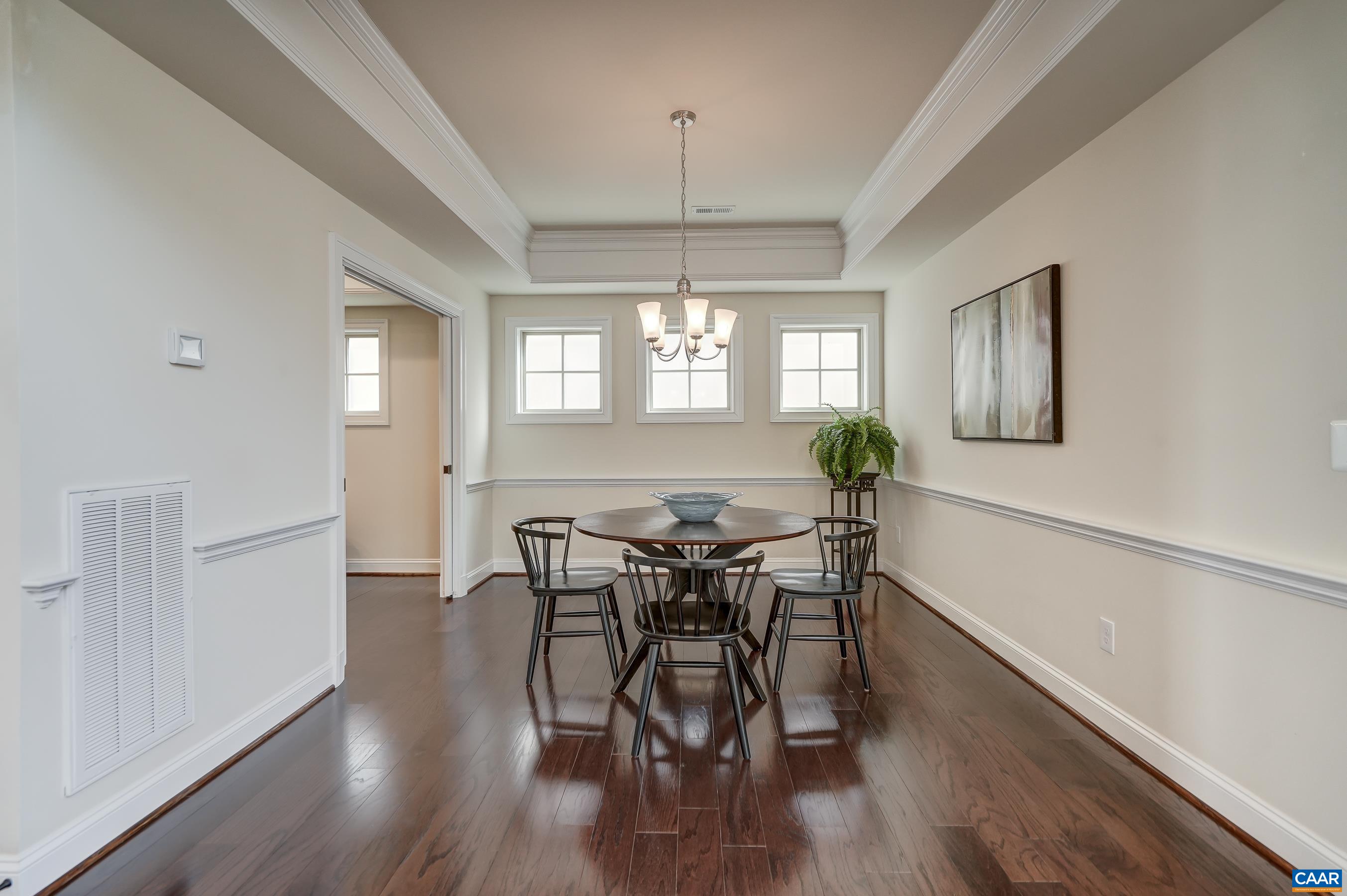 Formal dining room with chair rail and frosted windows.