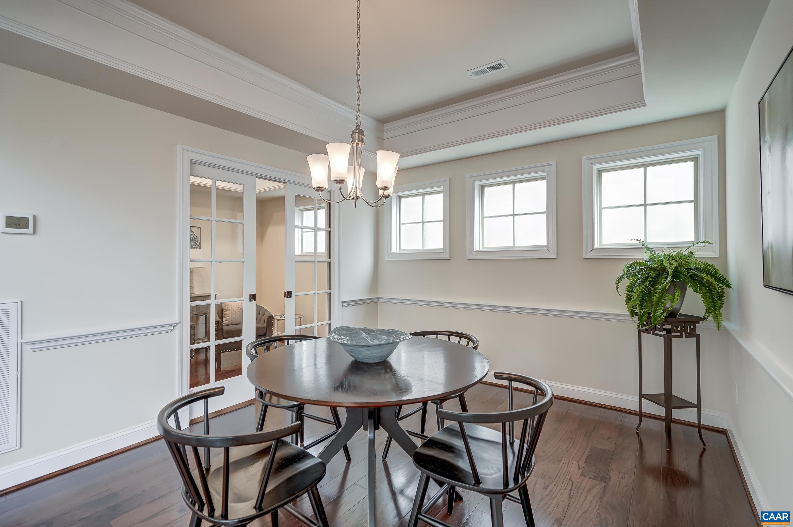 Dining room with french doors leading to home office/wine room.