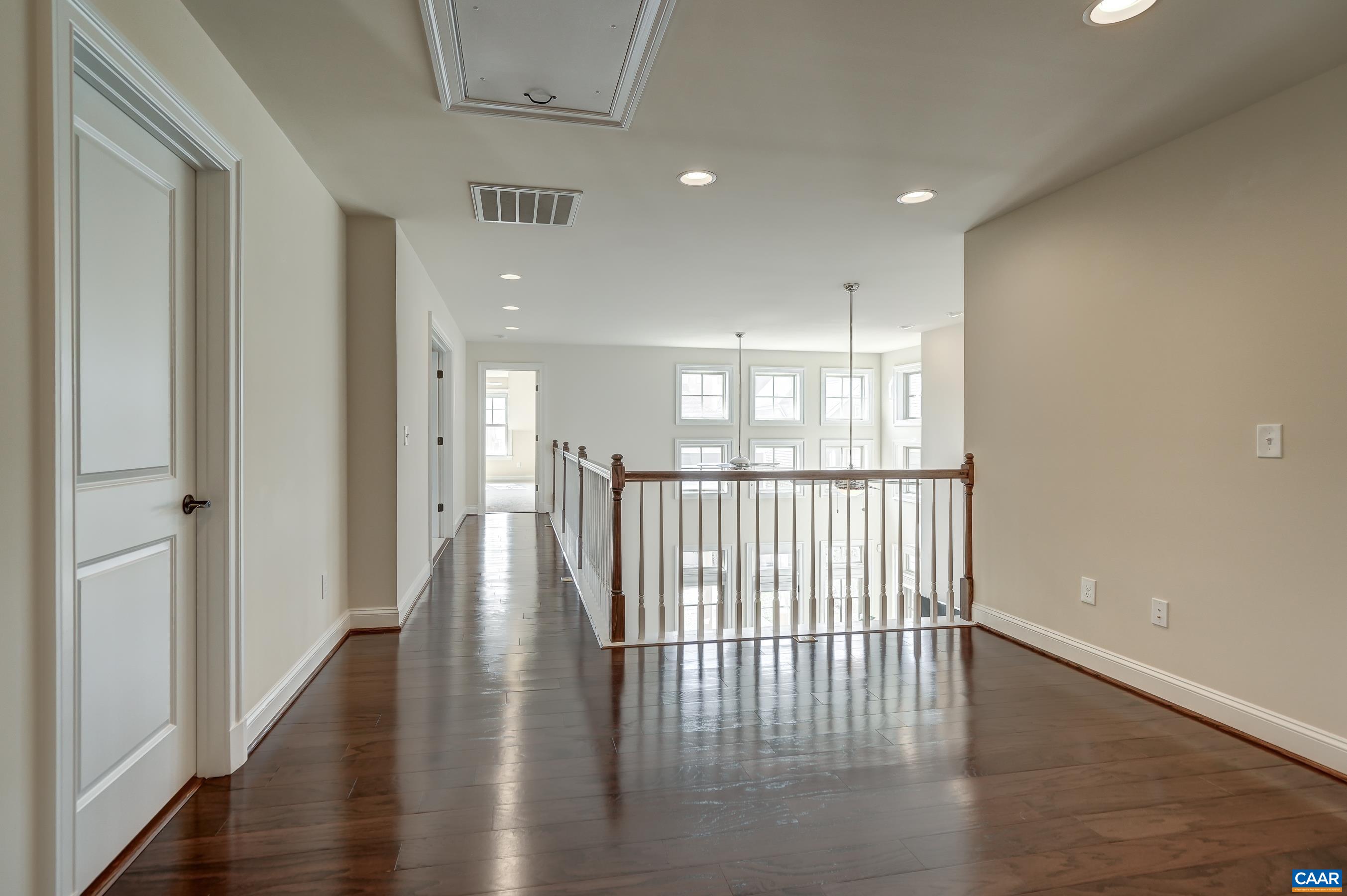 Hardwood floors in the second floor hallway overlooking the great room.