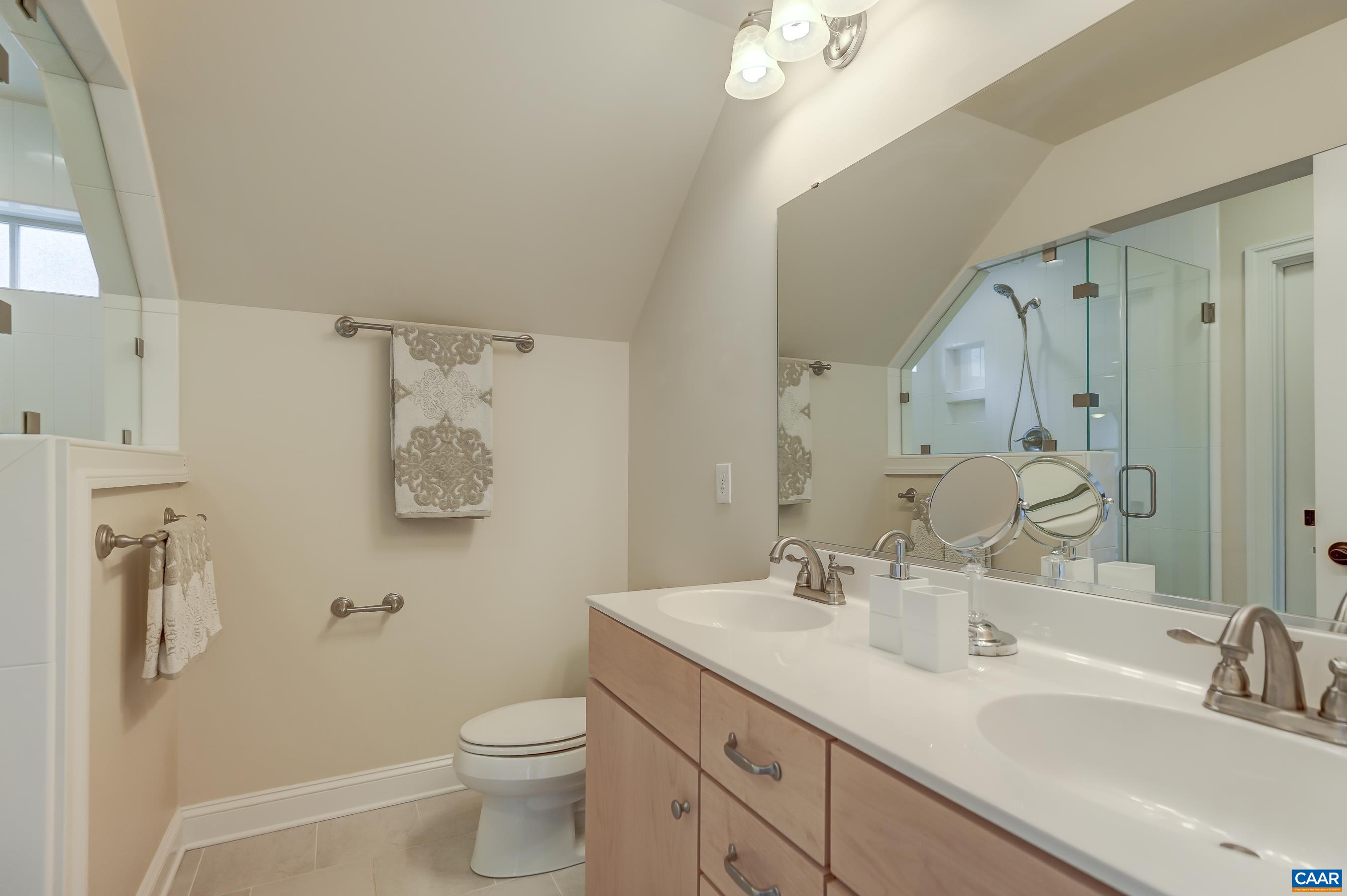 Jack and Jill bathroom with frameless glass shower.