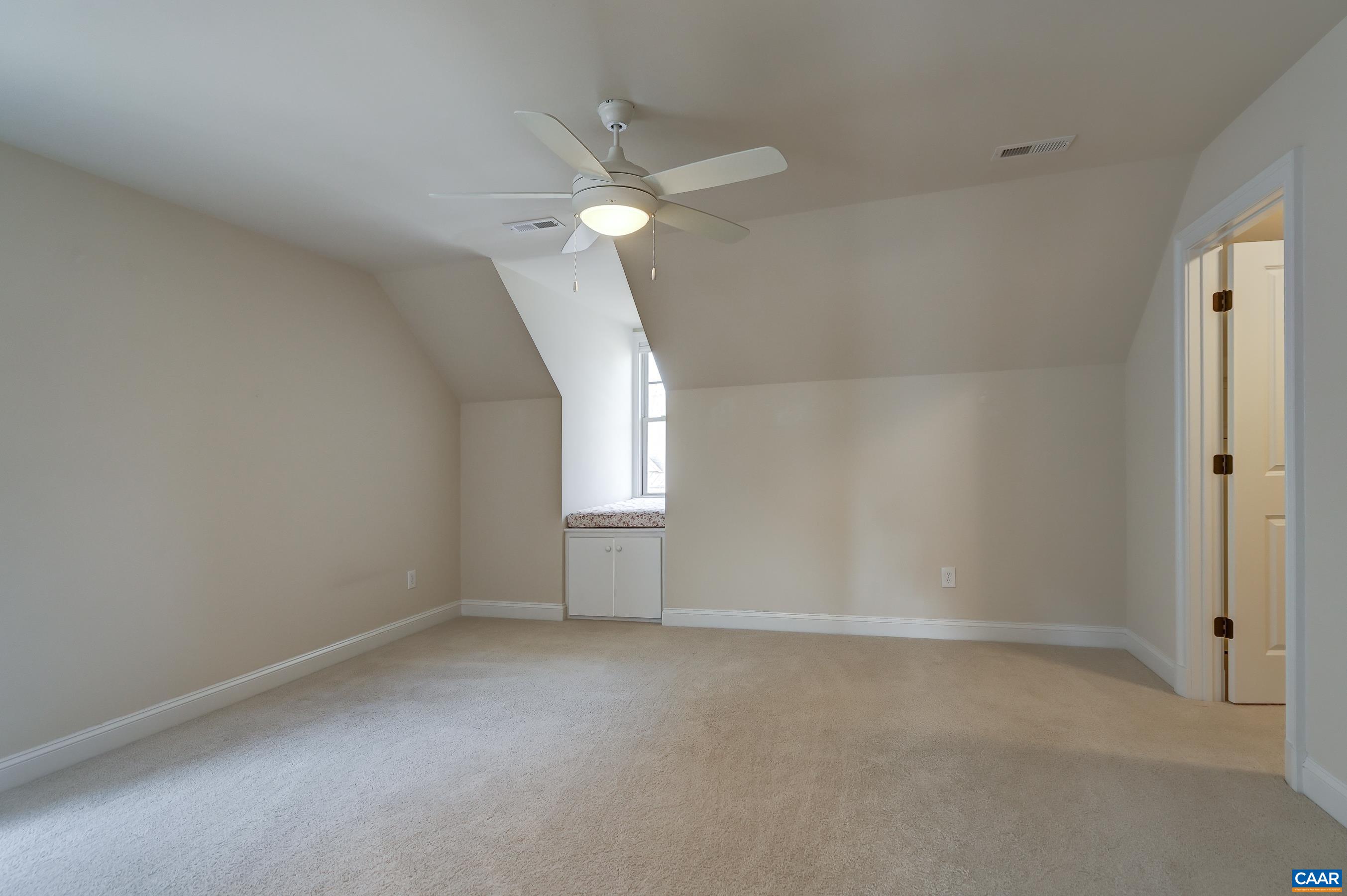 Bedroom 2 with dormer window/reading nook, large walk-in closet and private bathroom.