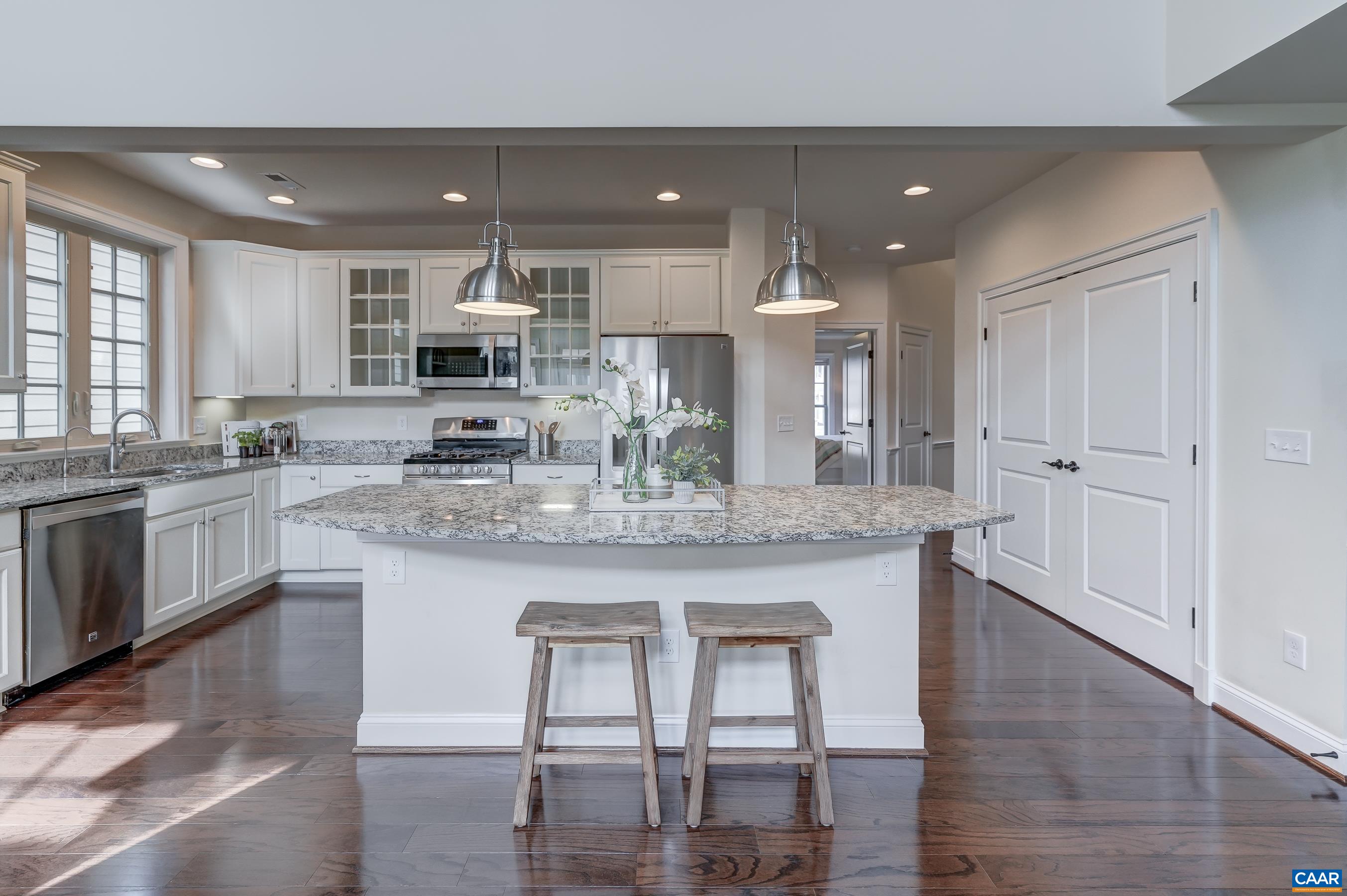 Large double-door pantry for extra kitchen storage.