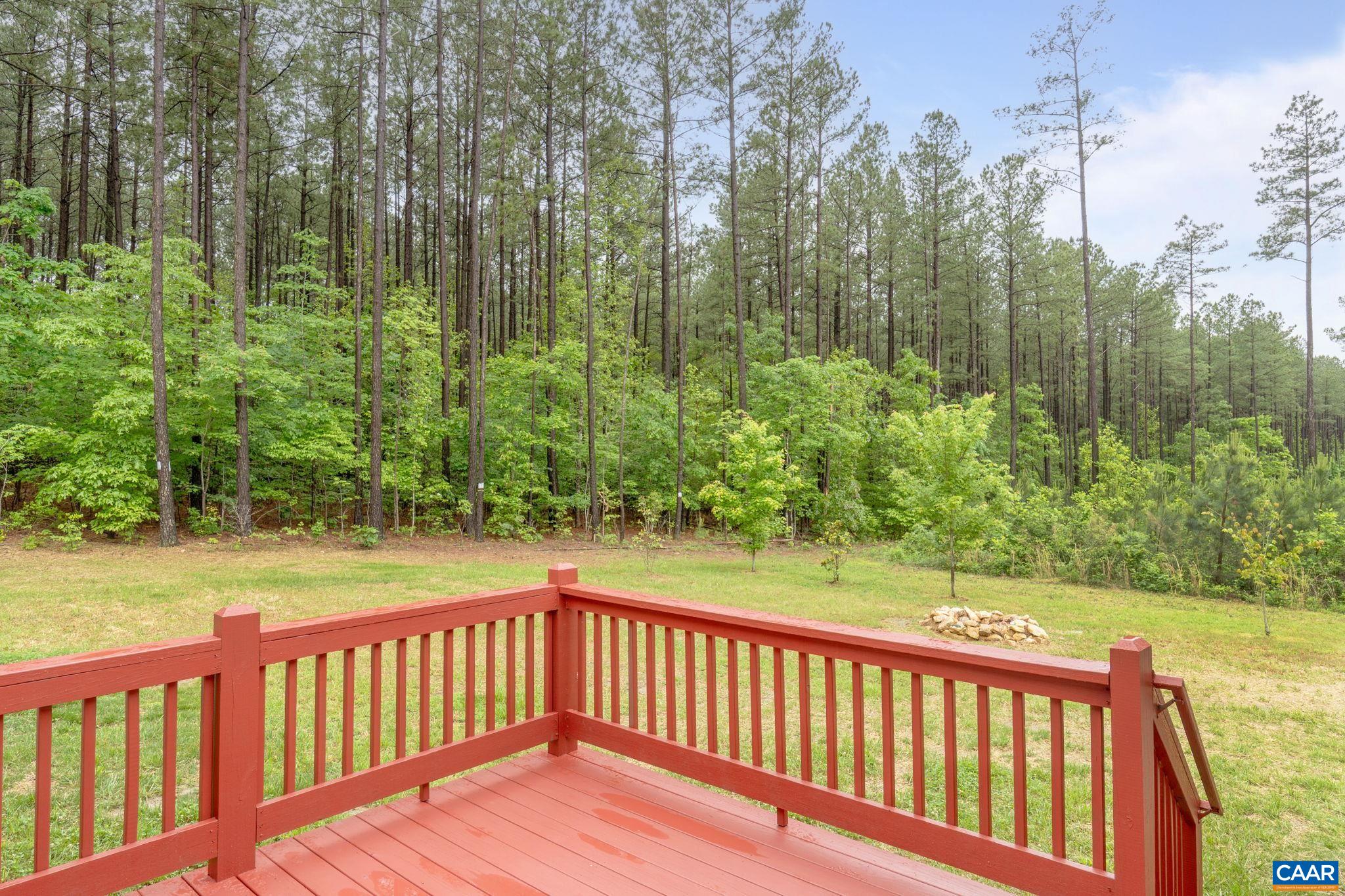 Nice sized cleared backyard with wooded acreage included beyond.
