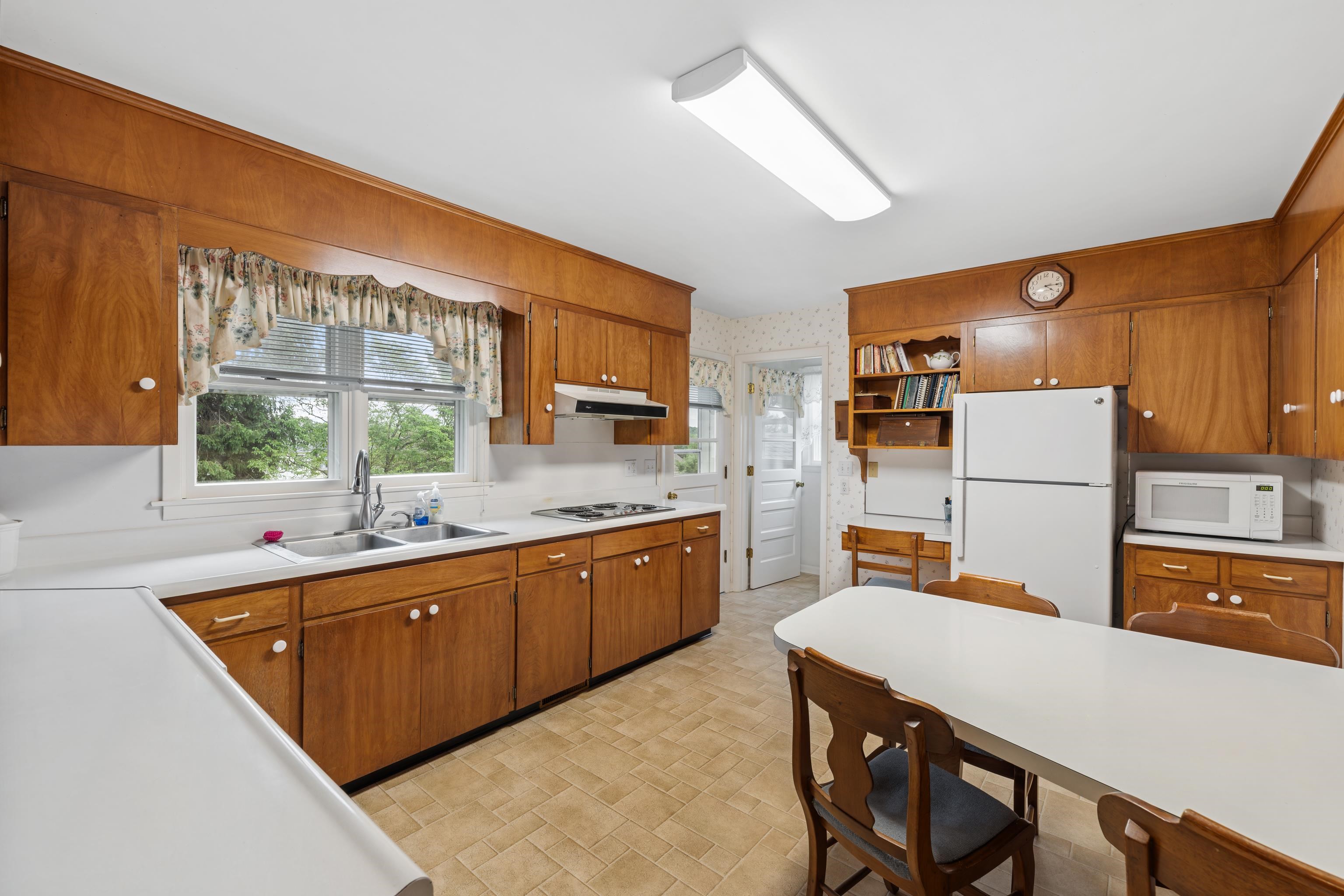 *Vinyl flooring, wood cabinets, Formica counters, built-in table, and all appliances.