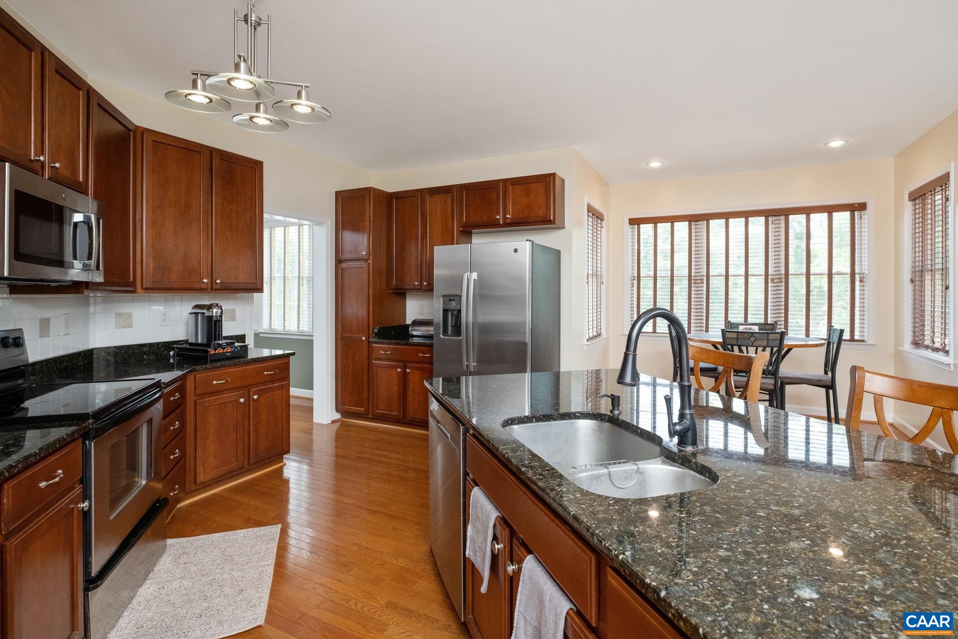 Island with sink in view. The refrigerator, dishwasher, and microwave are about 2-3 years old.