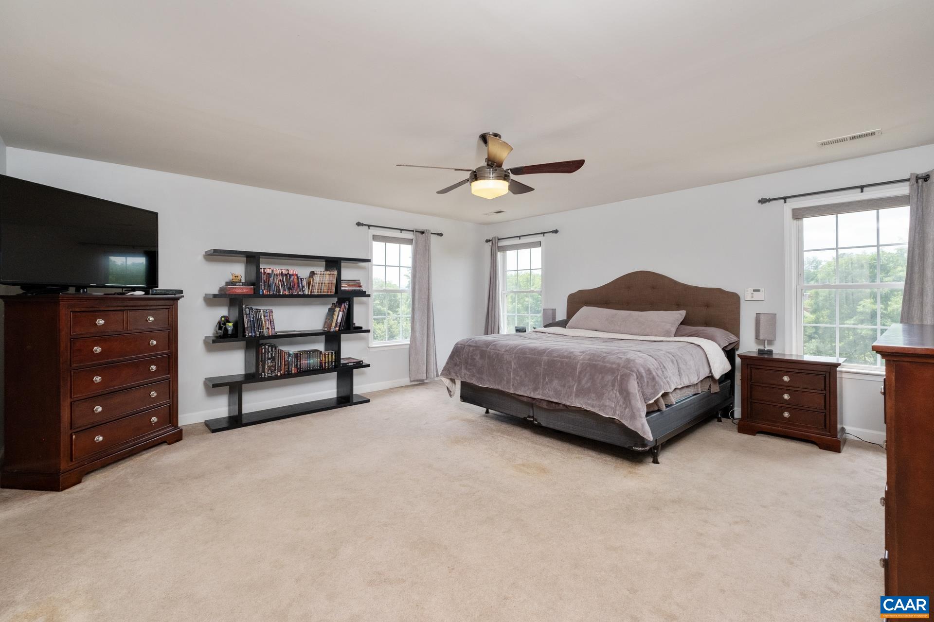 Primary suite features French doors and plenty of natural light.