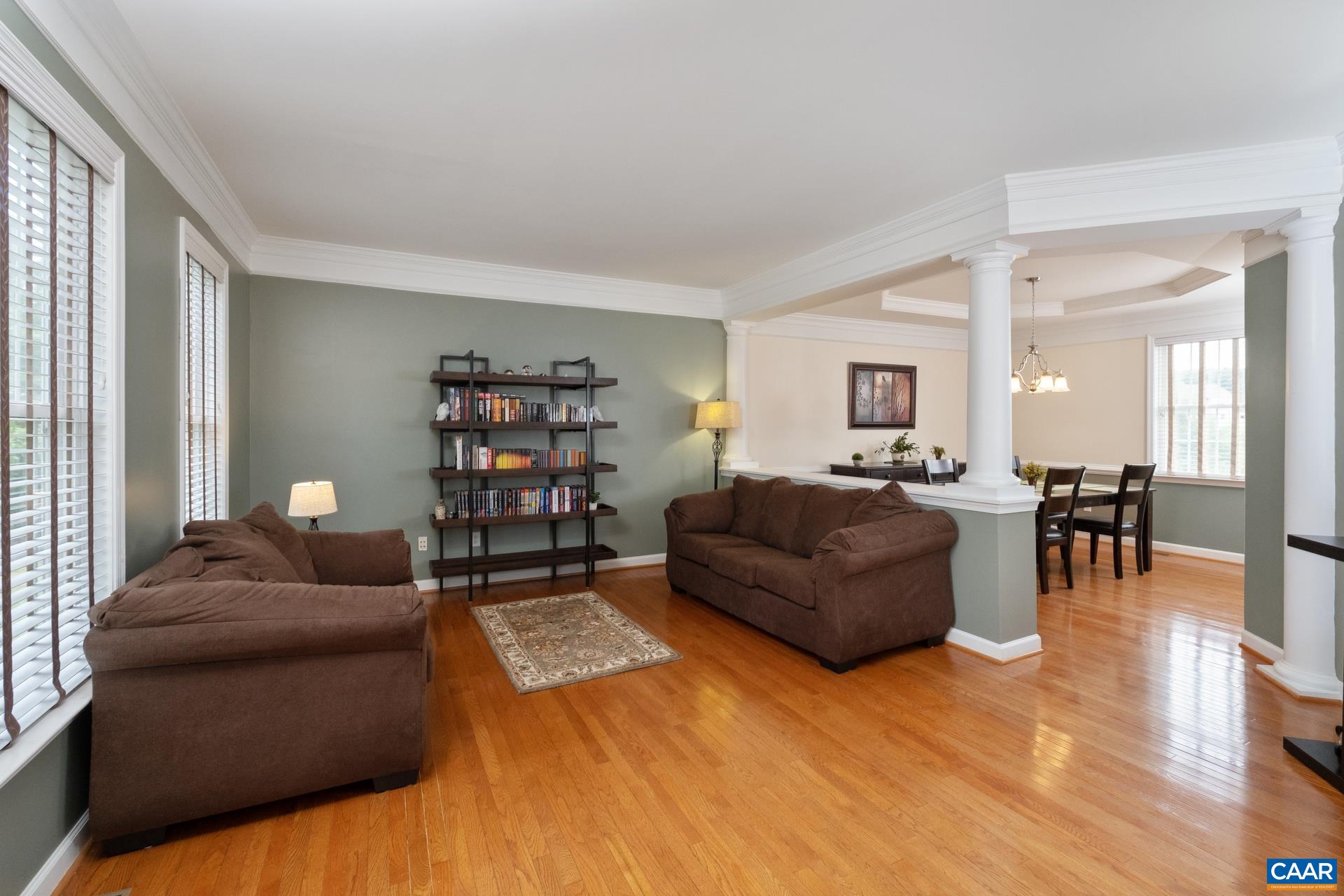 Sitting area/living room opens to the foyer and dining room. Beautiful columns in view.