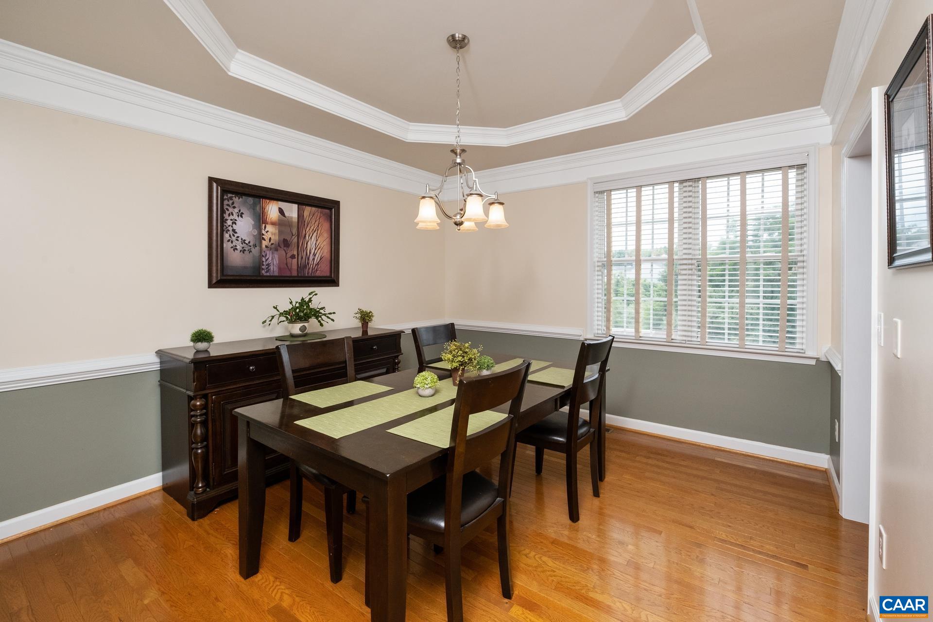Dining room features tray ceiling, columns, and plenty of natural light.
