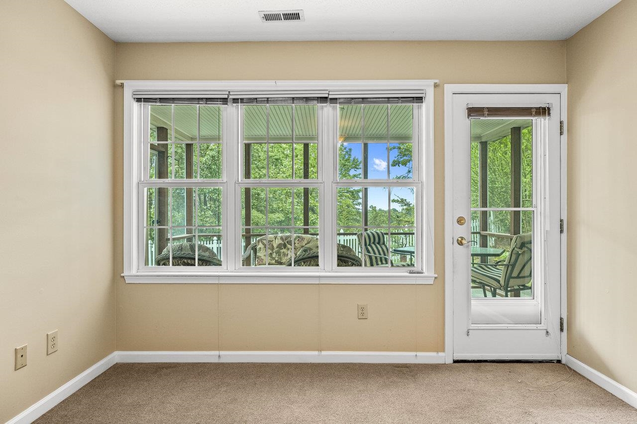 At the end of the hallway, the Den opens out to the backyard screen porch