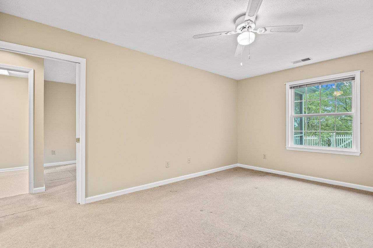 This spacious room has a ceiling fan, walk-in closet and attached full bath