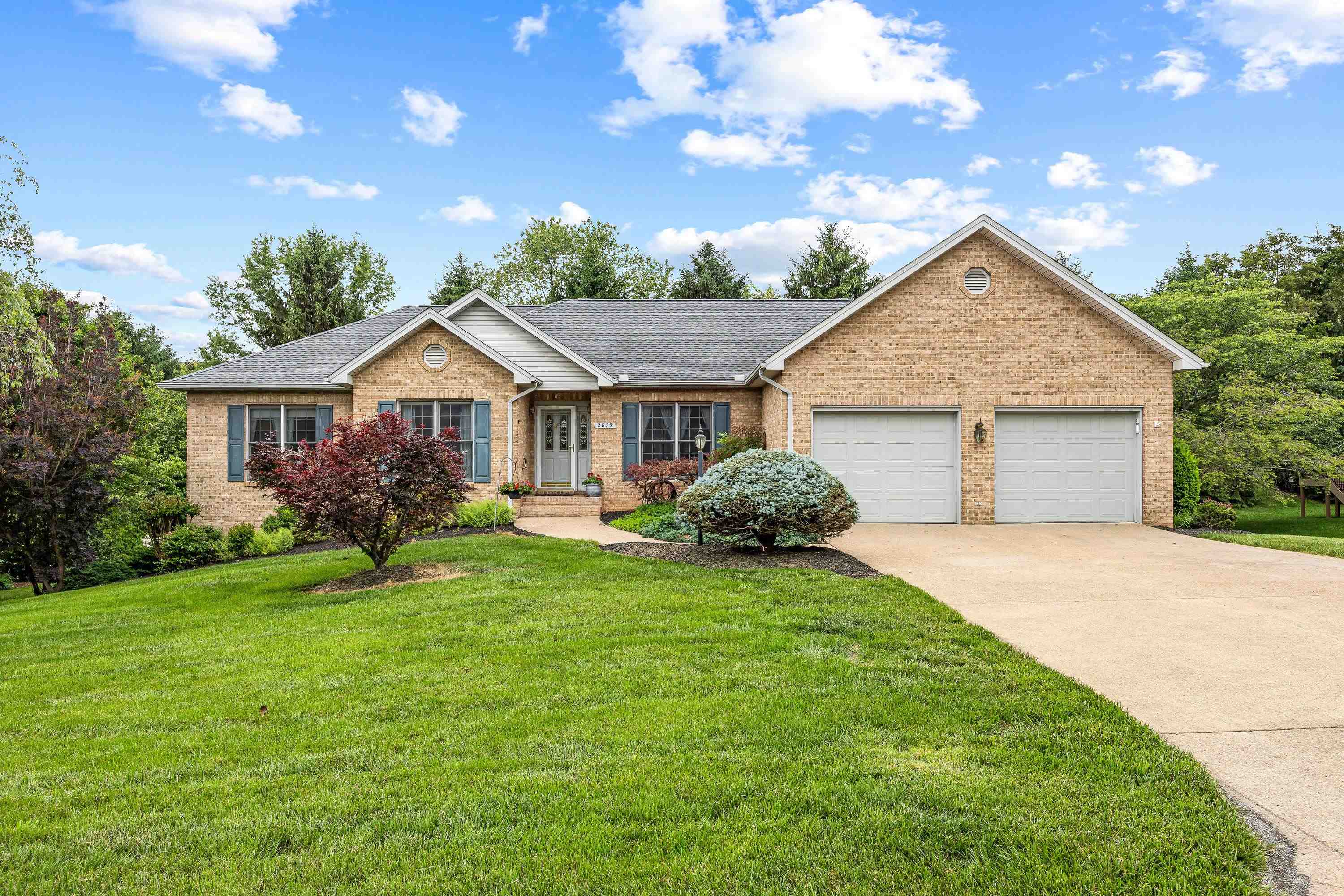 The front view of the beautiful home located at 2875 Barrington Drive in the lovely and established neighborhood of Barrington Estates.  The front view highlights the brick exterior of the home, two car garage, and mature landscaping surrounding the home!