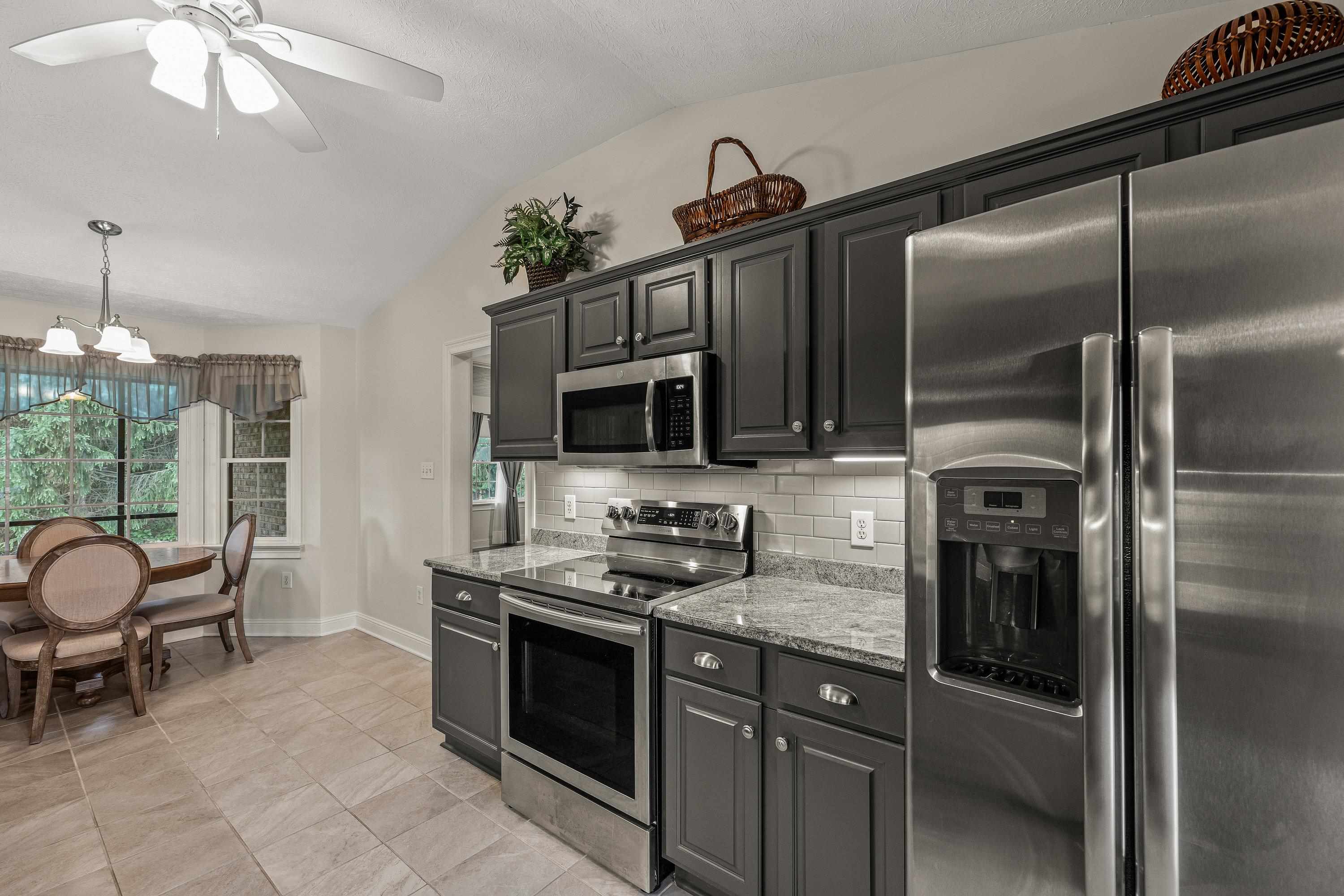 The updated kitchen contains new cabinetry, granite counter-tops, ceramic tile flooring, under cabinet lighting, and stainless steel appliances!