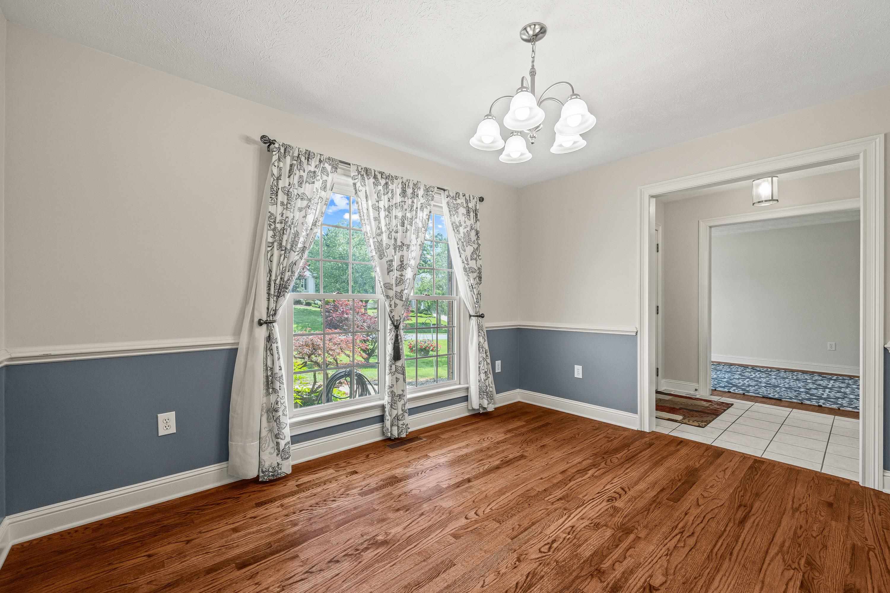 The spacious dining room offers hardwood flooring throughout, update light fixture, and plenty of room for a table and chairs set.