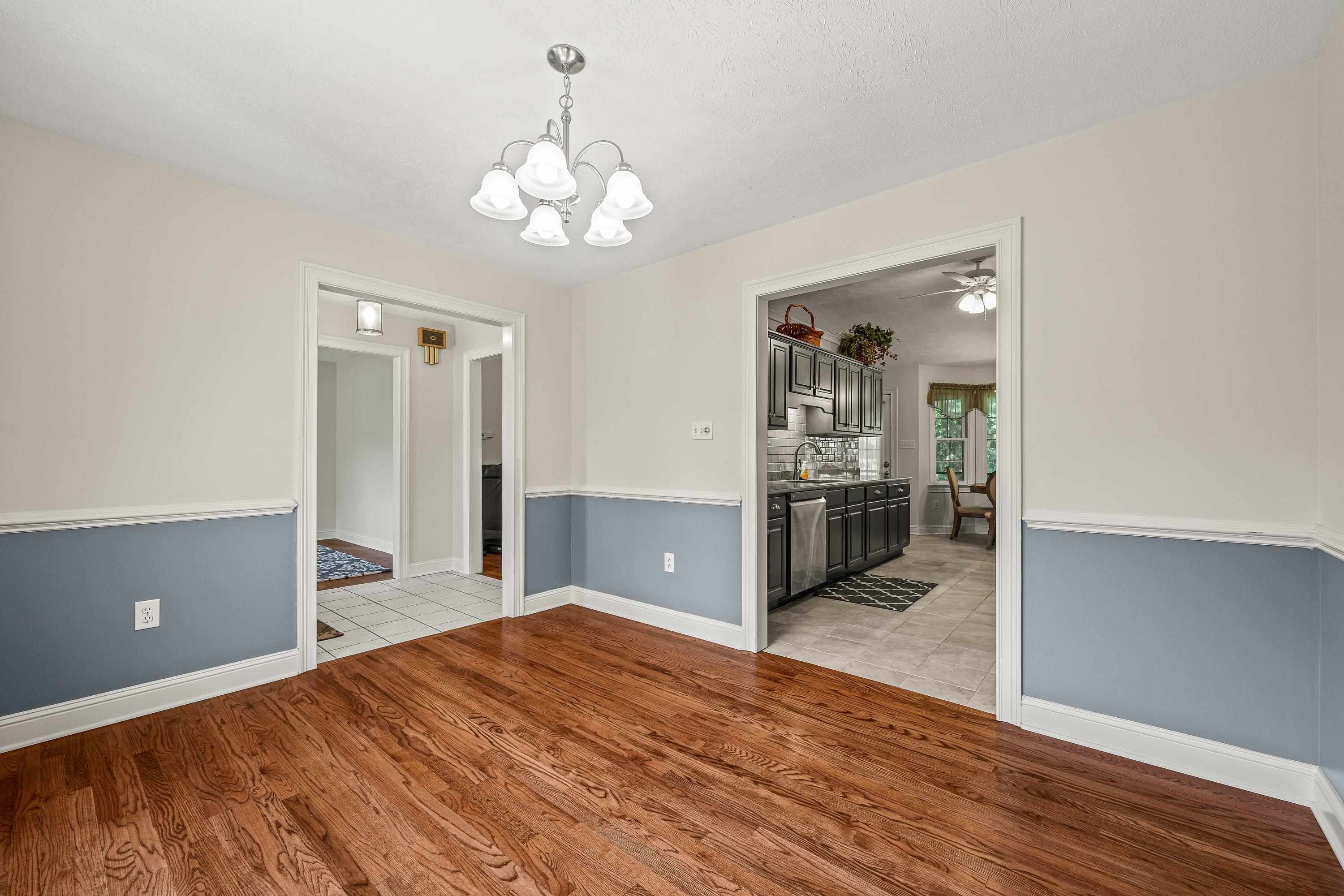 The spacious dining room offers hardwood flooring throughout, update light fixture, and plenty of room for a table and chairs set.