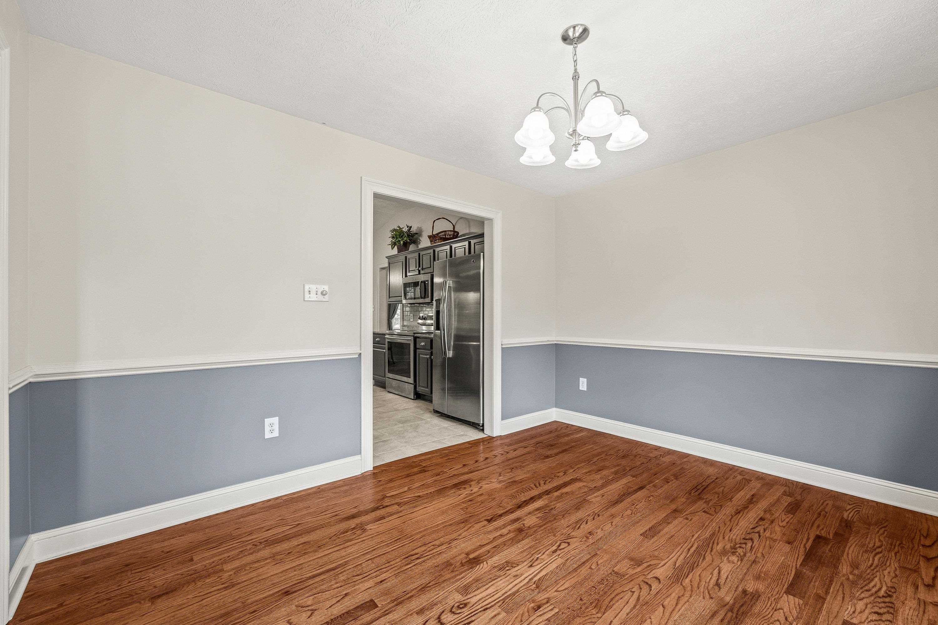 The spacious dining room offers hardwood flooring throughout, update light fixture, and plenty of room for a table and chairs set.