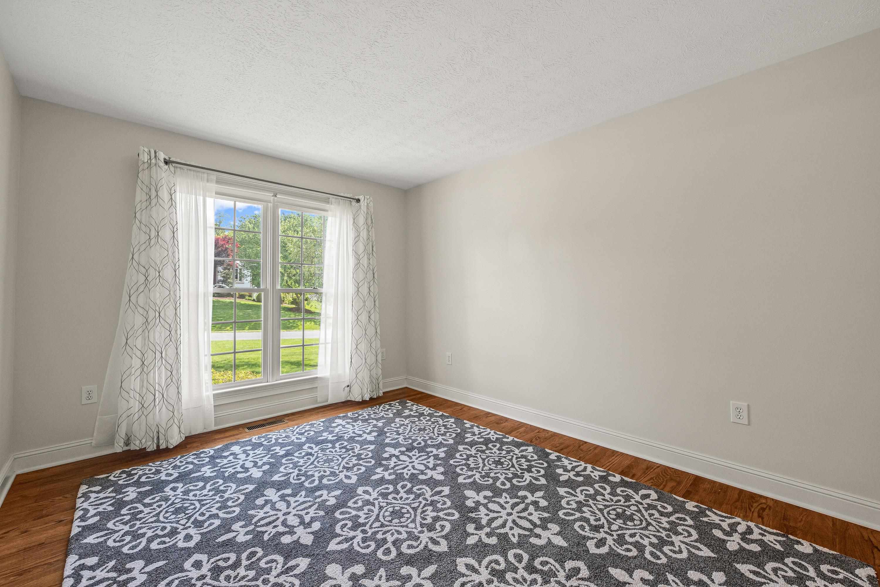 This large room can be used as formal living room, home office, and more!  This space offers hardwood flooring throughout.