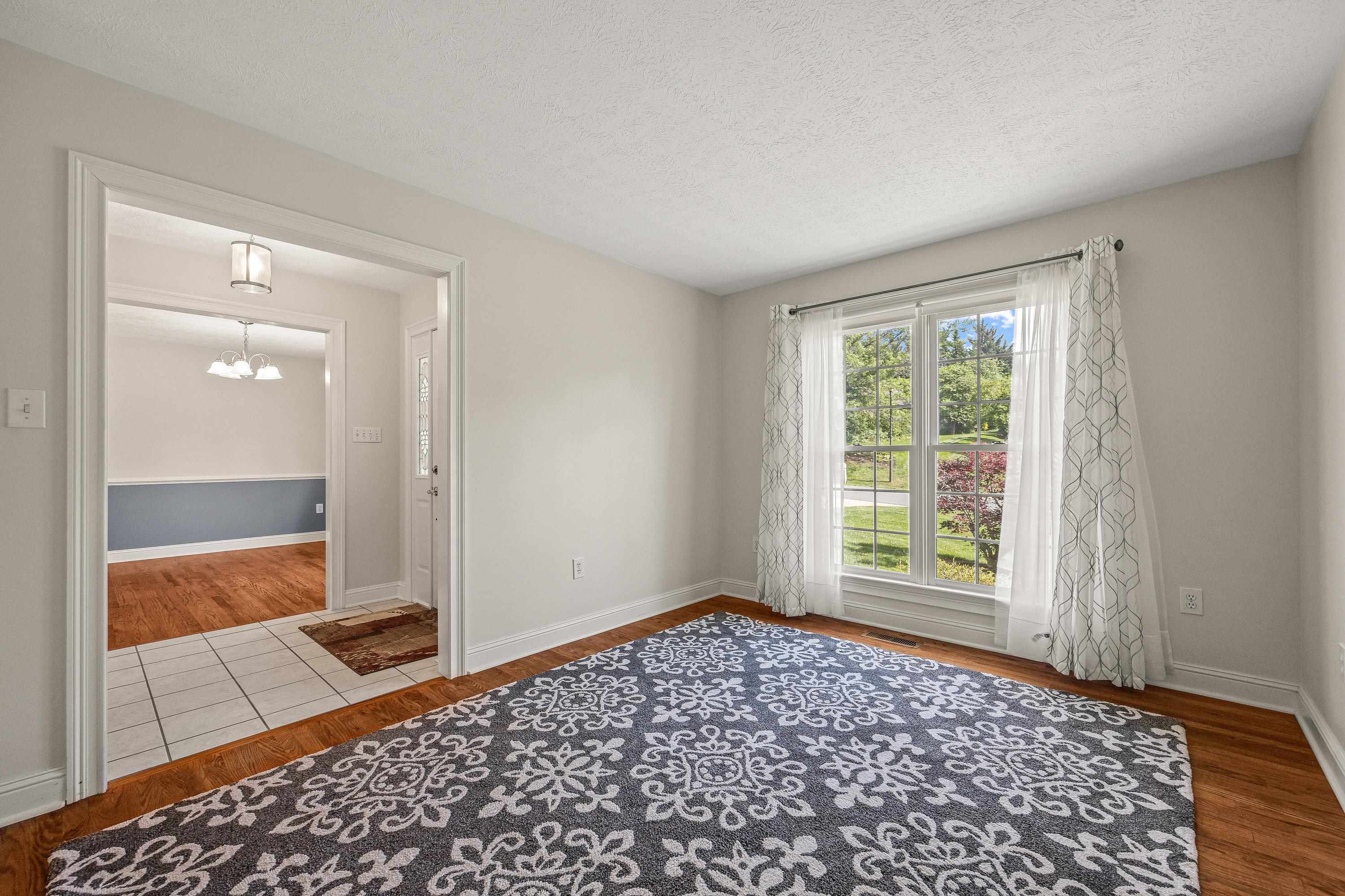 This large room can be used as formal living room, home office, and more!  This space offers hardwood flooring throughout.