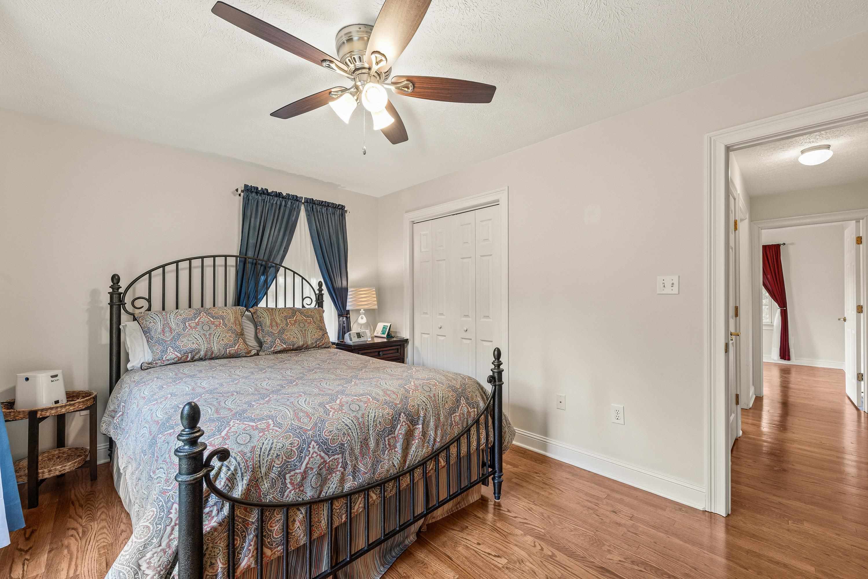 The second bedroom located on the main level offers a ceiling fan, hardwood flooring, and multiple windows allowing in an abundance of natural light!