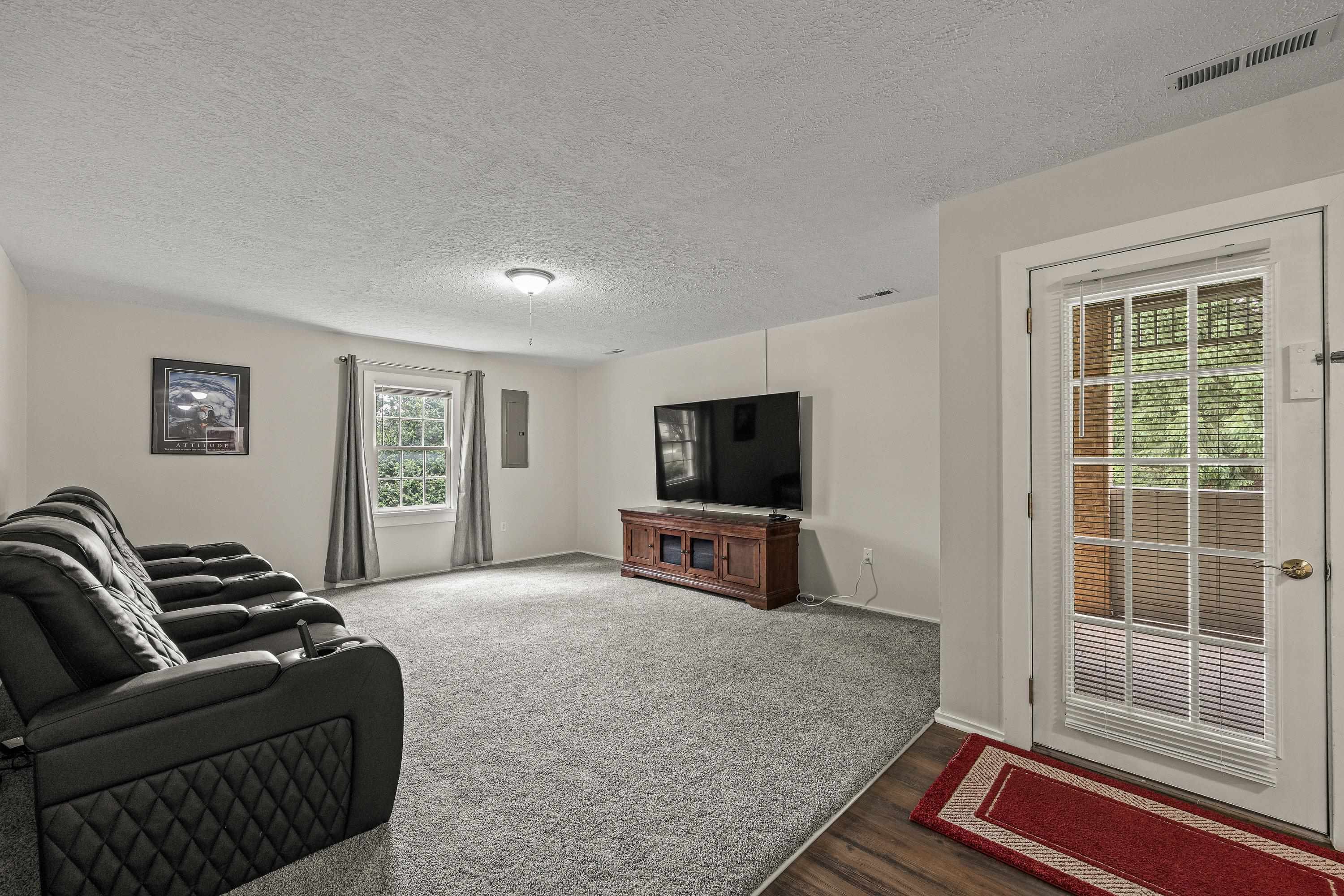 This large room offers luxury vinyl plank throughout, recessed lighting, oversized window, and is a perfect space for use as a home theatre or additonal living room.