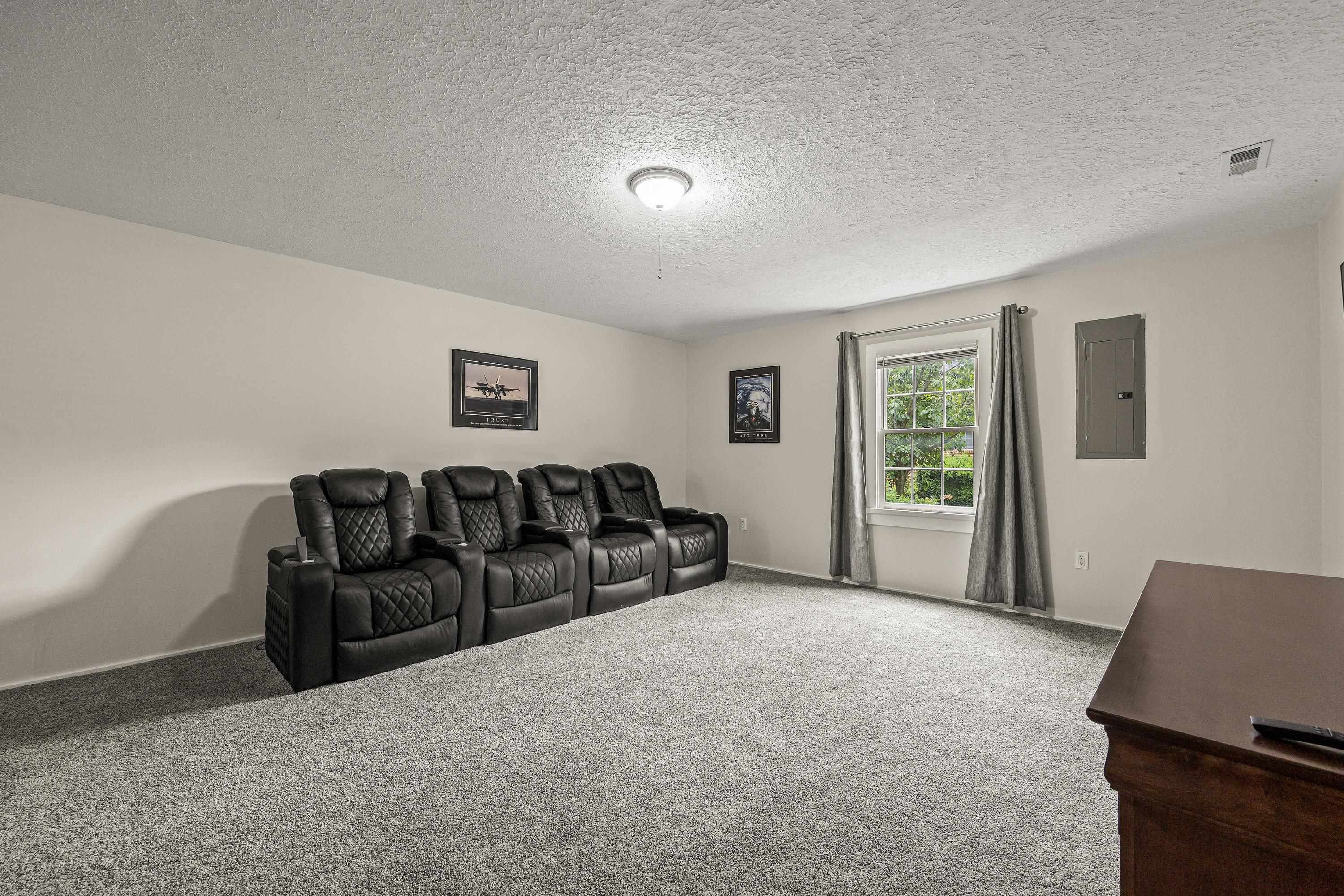 This large room offers luxury vinyl plank throughout, recessed lighting, oversized window, and is a perfect space for use as a home theatre or additonal living room.