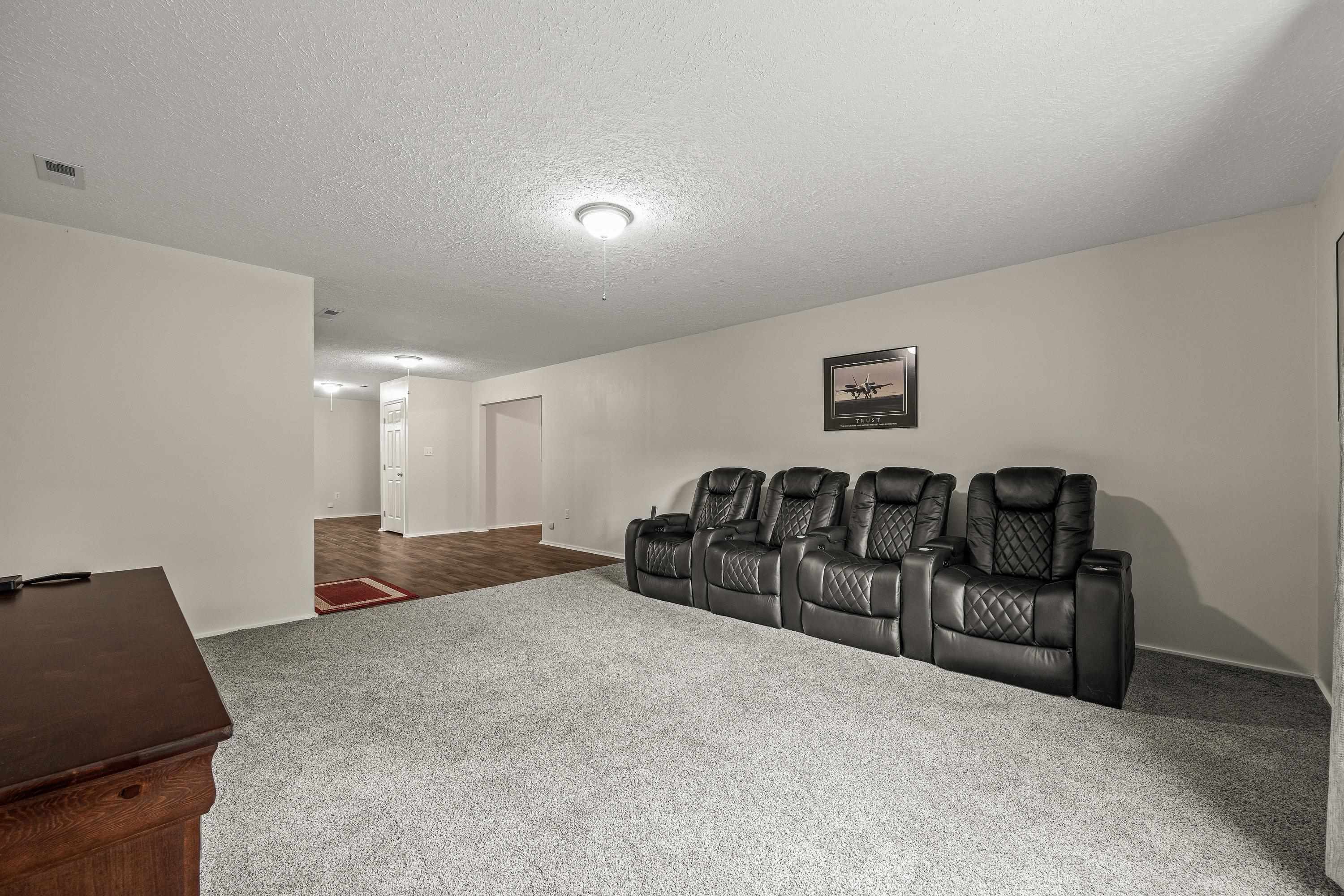 This large room offers luxury vinyl plank throughout, recessed lighting, oversized window, and is a perfect space for use as a home theatre or additonal living room.