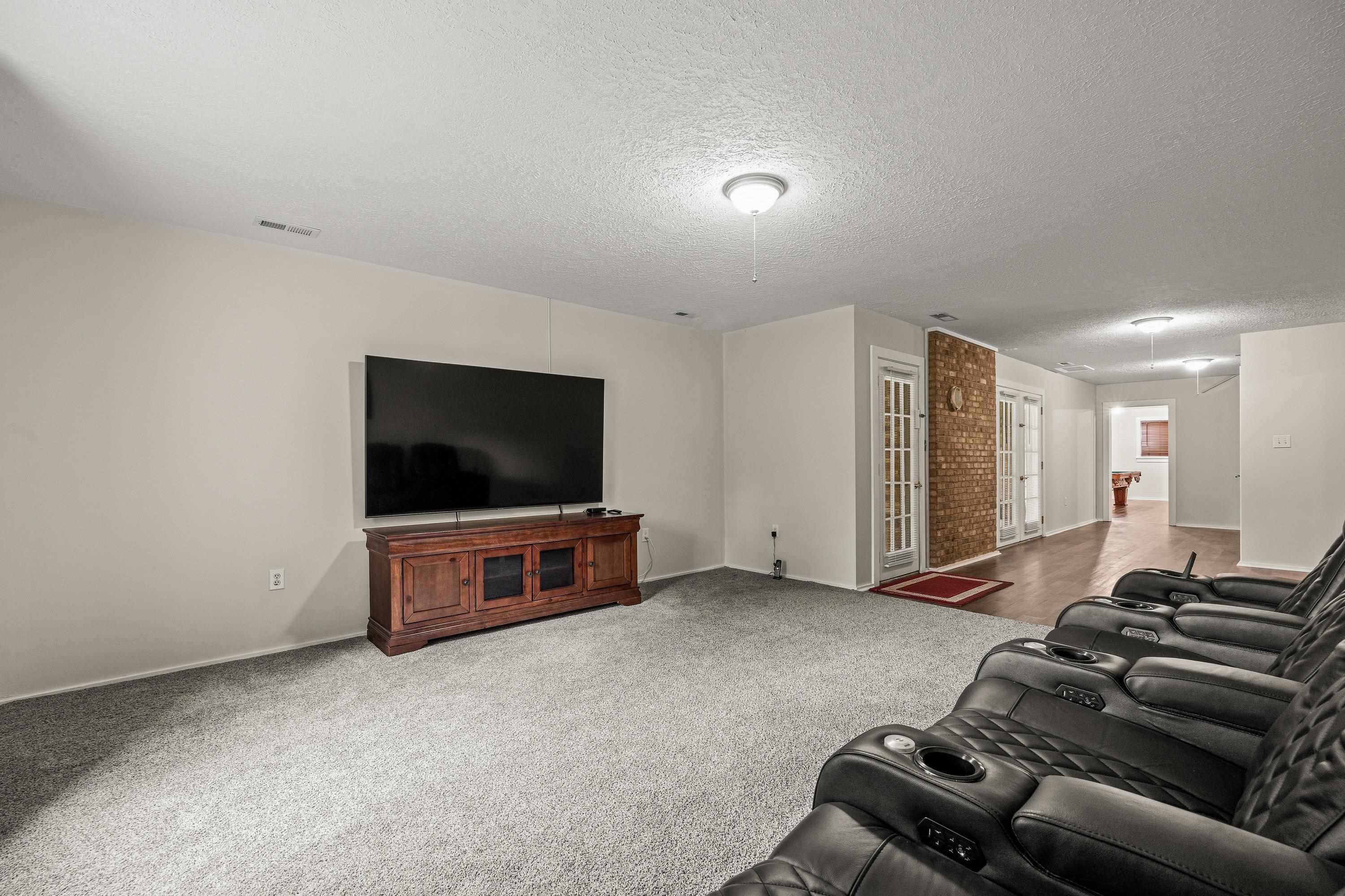 This large room offers luxury vinyl plank throughout, recessed lighting, oversized window, and is a perfect space for use as a home theatre or additonal living room.