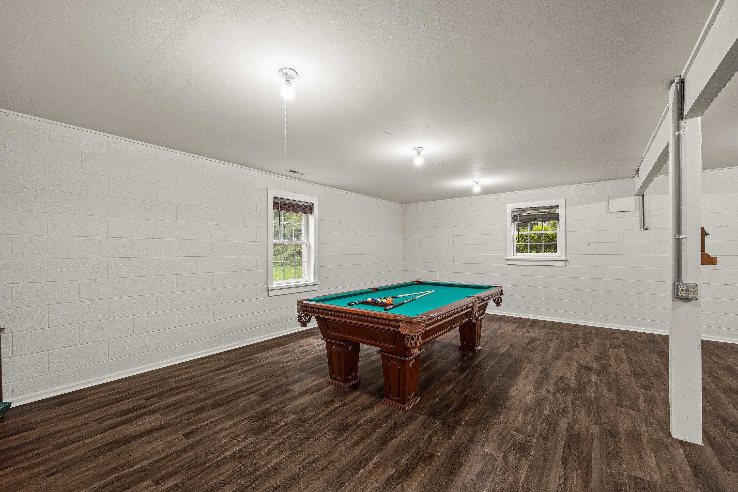 A billiard table in an added bonus in this very large game room.  This space offers luxury vinyl plank flooring, recessed lighting, and much more!