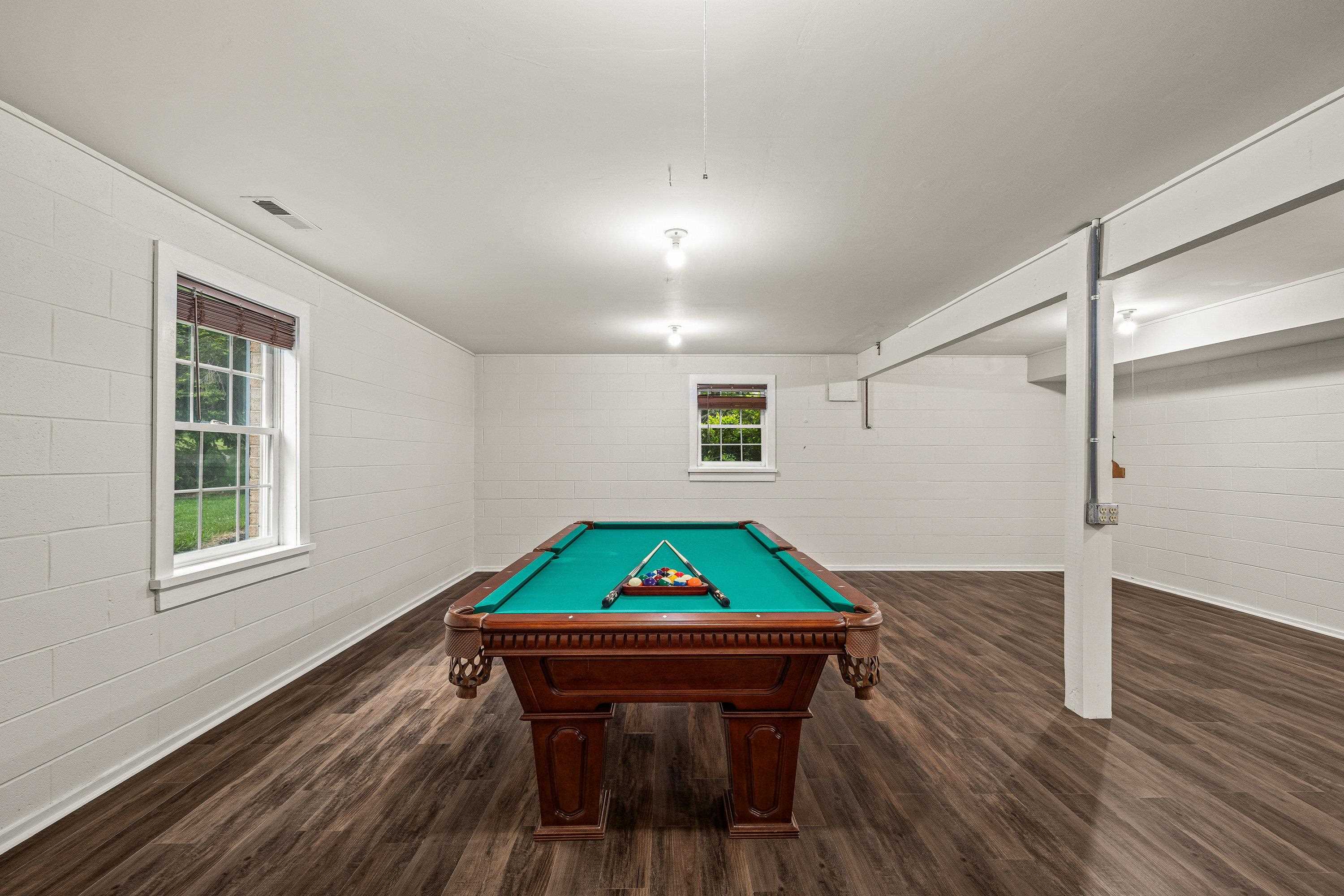 A billiard table in an added bonus in this very large game room.  This space offers luxury vinyl plank flooring, recessed lighting, and much more!